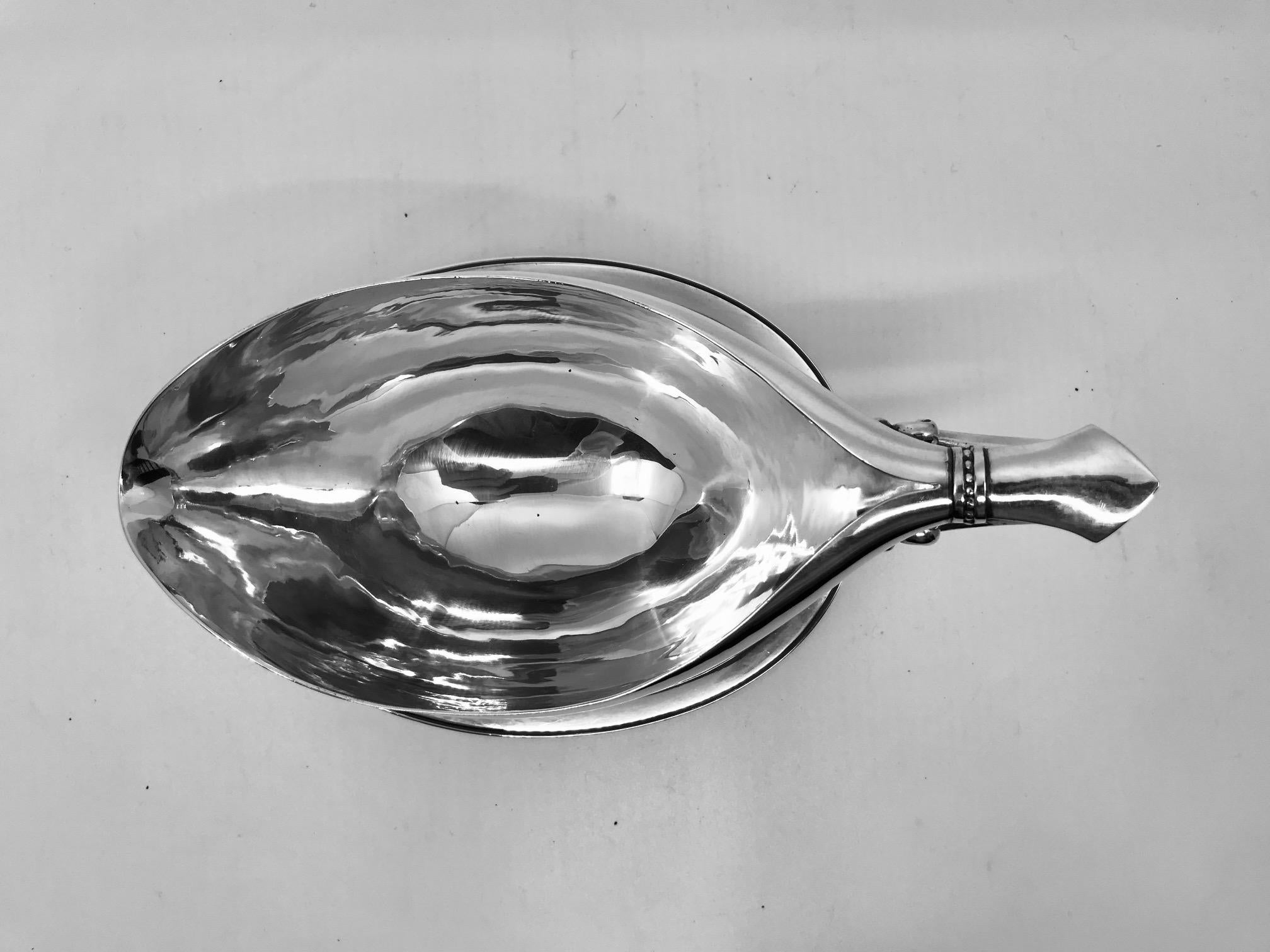 A hard to find Vintage sterling silver Georg Jensen sauce boat with attached tray, design #90B by Johan Rohde.
Measures: 4½” in height to top of handle, the tray measures 6 7/8? x 5 1/4? (11cm, 17.5cm x 13.2cm).
Vintage Georg Jensen hallmarks from