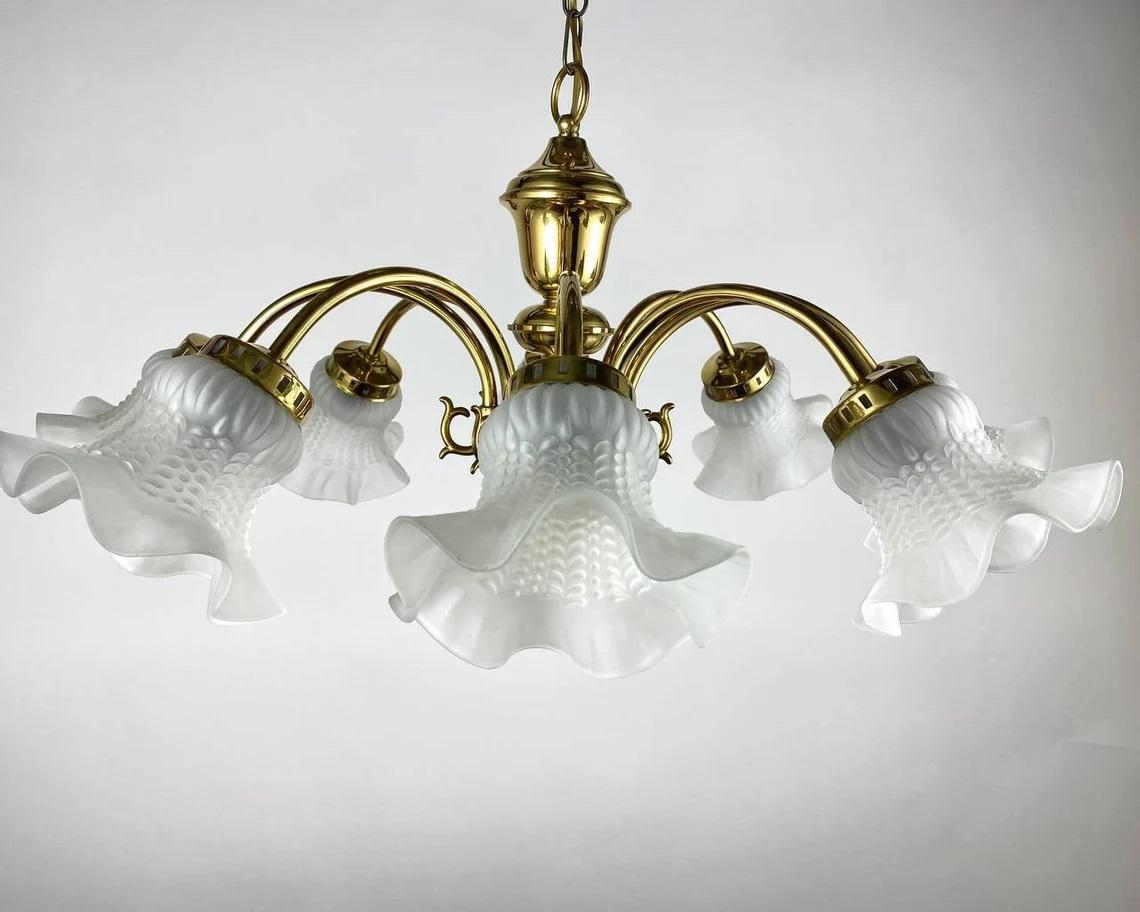 Large Vintage Chandelier with 6 light points is the quality in every detail of the lighting fixture.

The cast brass frame of gold color looks solid, and frosted glass shades in the shape of a flower add lightness.

Elegant chandelier is