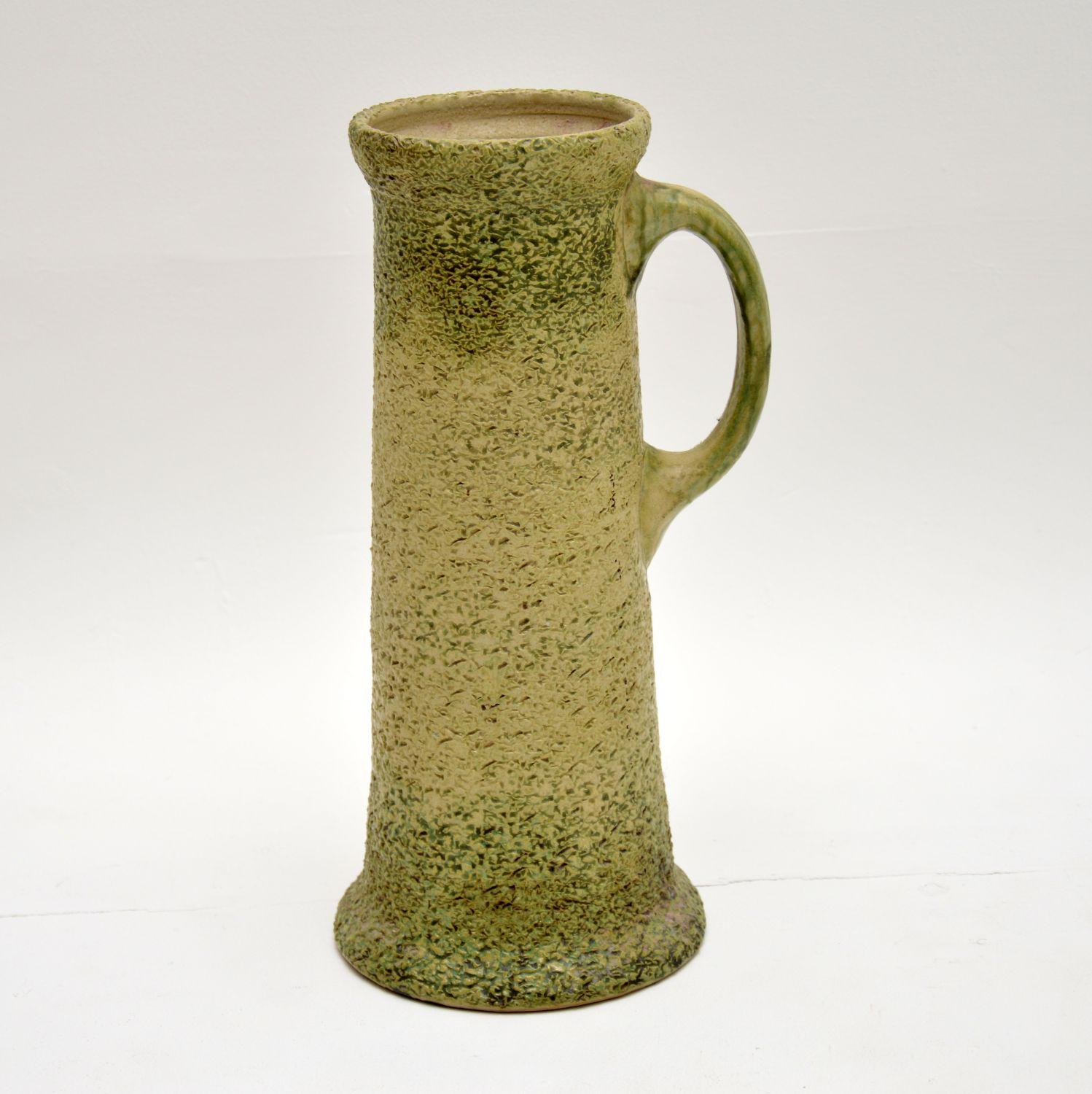 A large, beautiful and very interesting piece of glazed pottery, this pitcher dates from circa 1930s-1950s. It is of great quality and has a very unusual design, with a textured outer finish tinged with green and cream. It’s a very earthy and