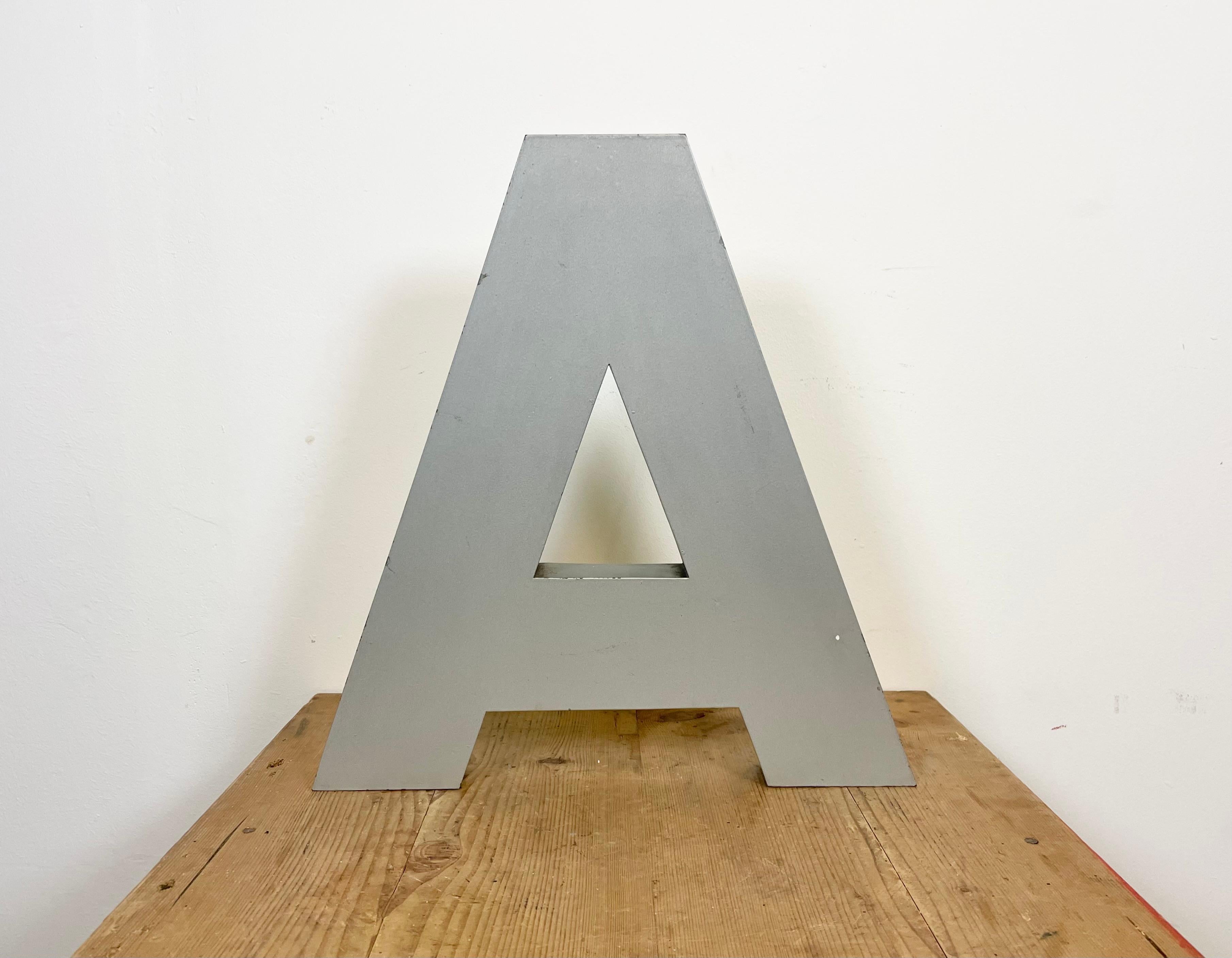 This vintage industrial facade letter “A” was made during the 1970s in Italy and comes from an old advertising banner. The weight of the letter is 1,7 kg.