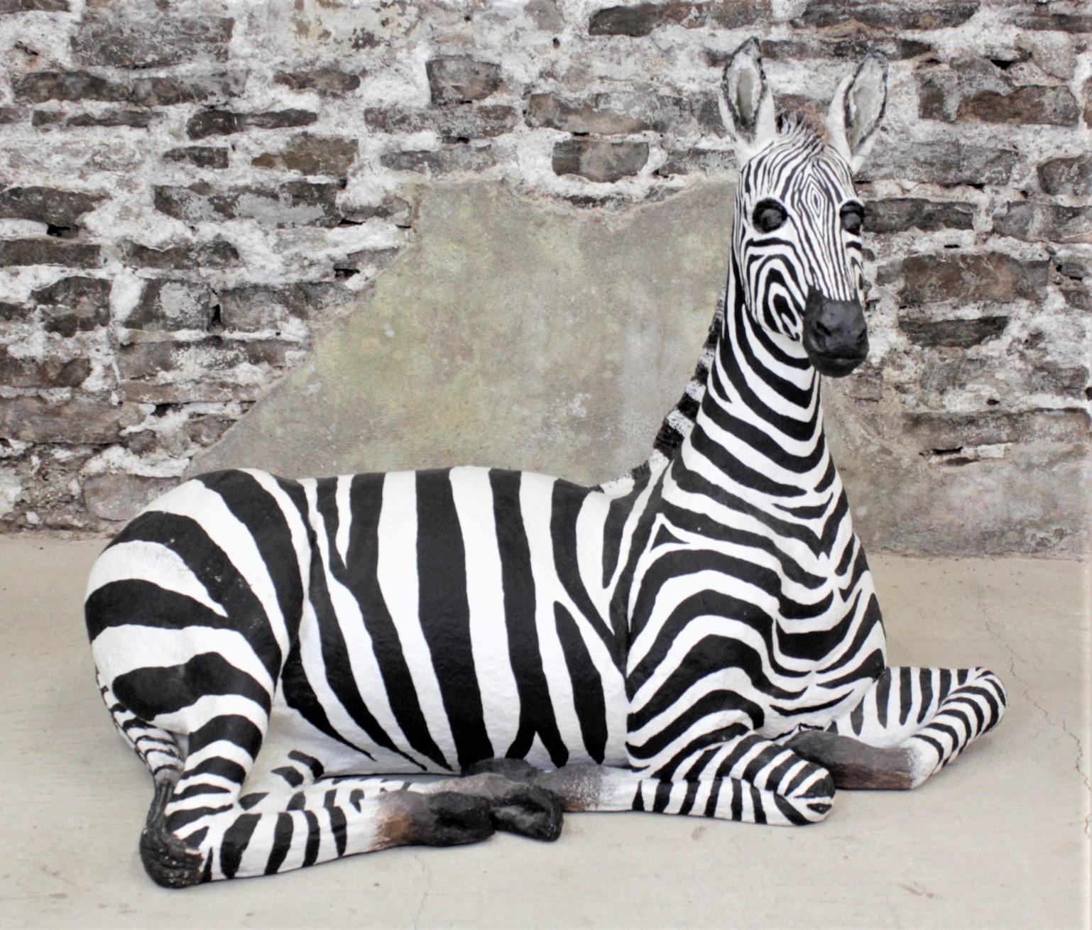 This large and substantial zebra sculpture was made by Monica Oliver, and unknown artist, in 1990 in a modern realistic style. The sculpture appears to be composed of various materials such as paper mache, fiberglass and resin and hand-painted. The
