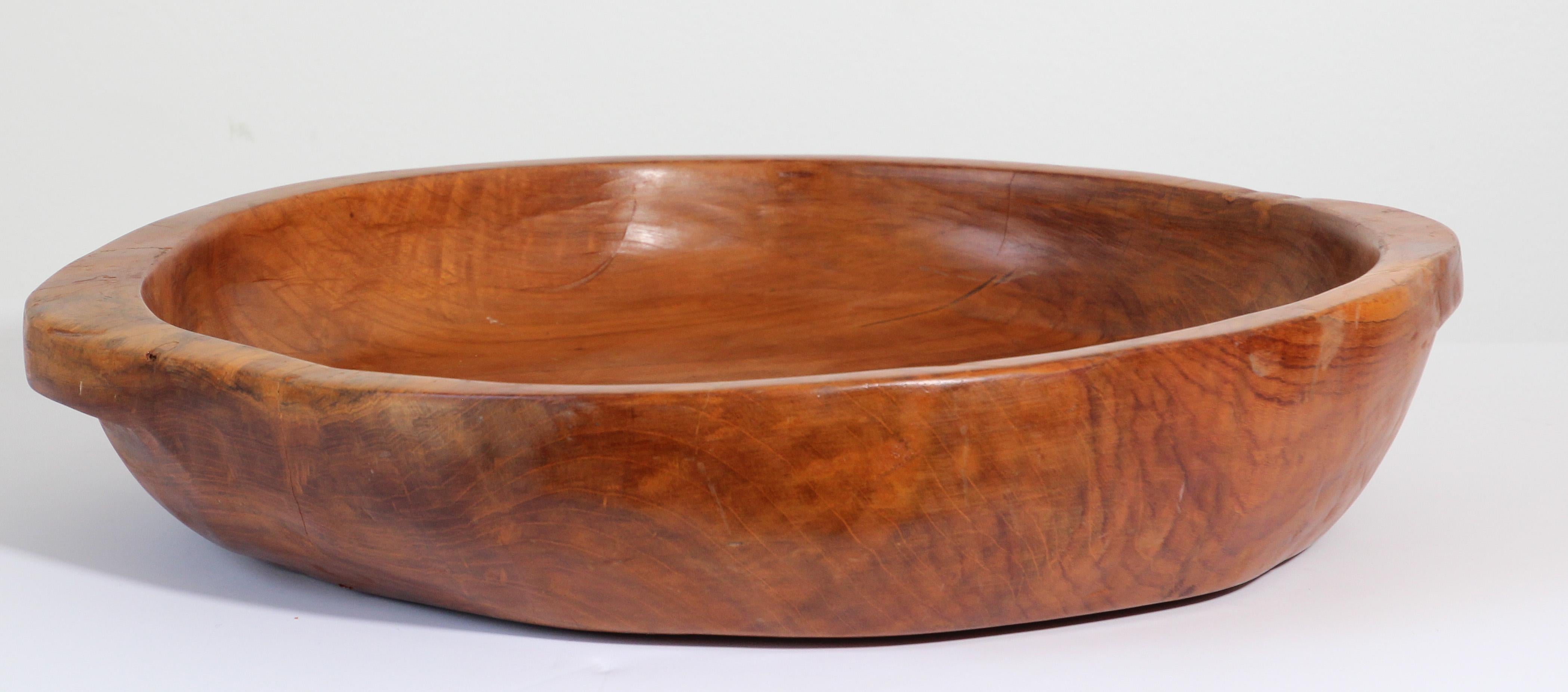 Large vintage teak burl wood bowl hand hewn, mid-20th century.
Unique organic sizable folk craft bowl round shape with handles.
This beautifully organic bowl is fashioned from a large burl wood. . 
Hewn from a single exceptional piece of old