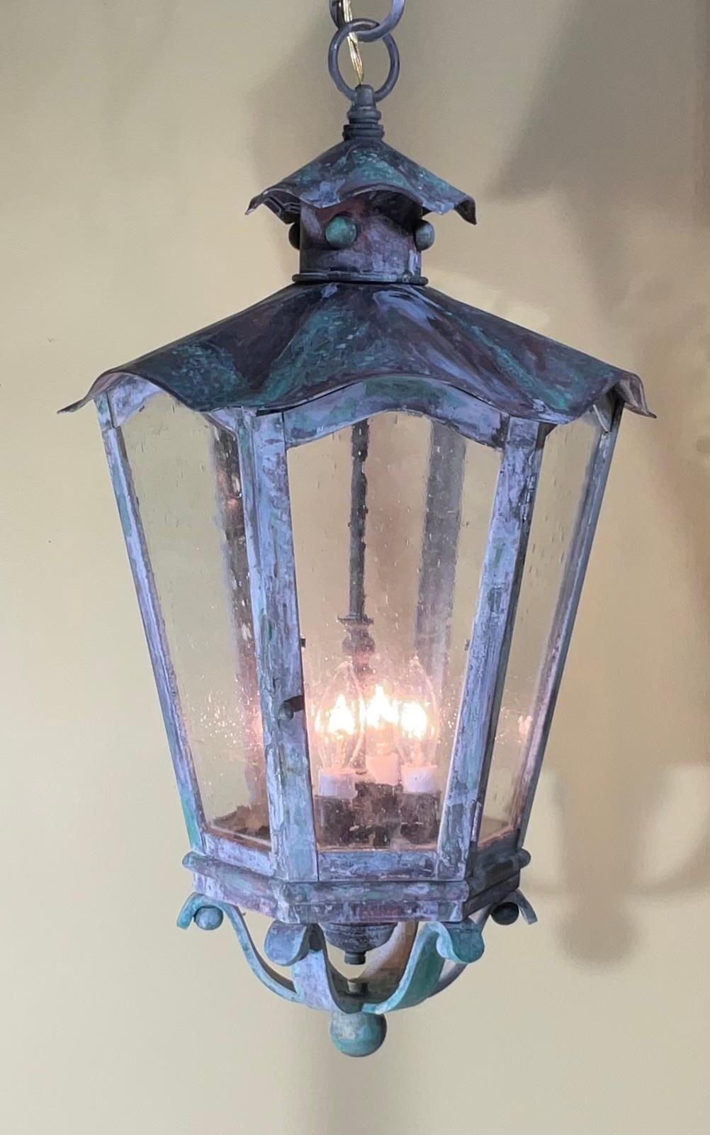 Exceptional six sides hanging lantern made of handcrafted solid brass , seeded glass, three 40/watt lights, suitable for wet location
Nice oxidise patina , great look indoor outdoor. 
canopy and chain included.