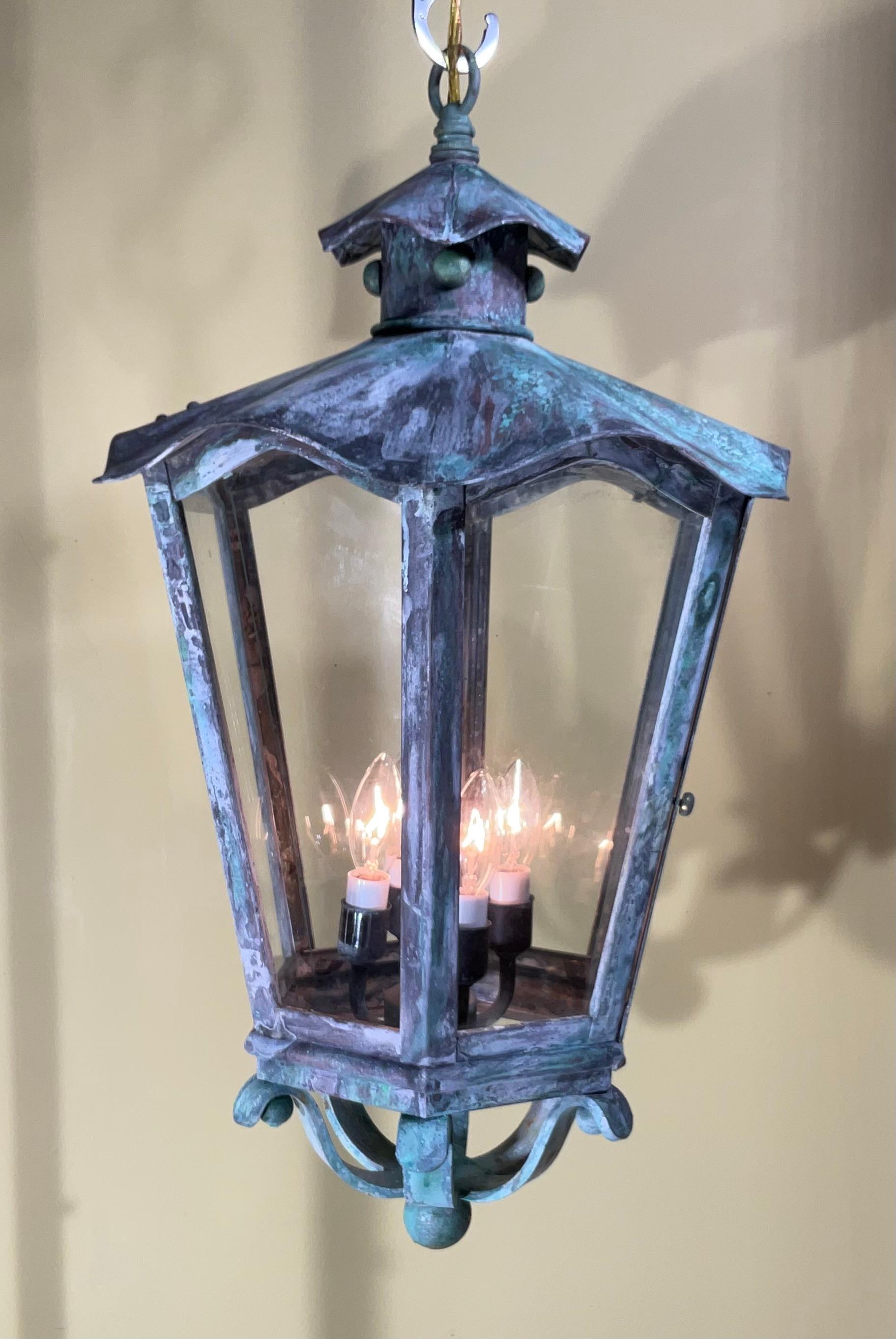 Exceptional six sides hanging lantern made of handcrafted solid brass , clear glass, four 40/watt lights, suitable for wet location
Nice oxidise patina , great look indoor outdoor. 
canopy and chain included.