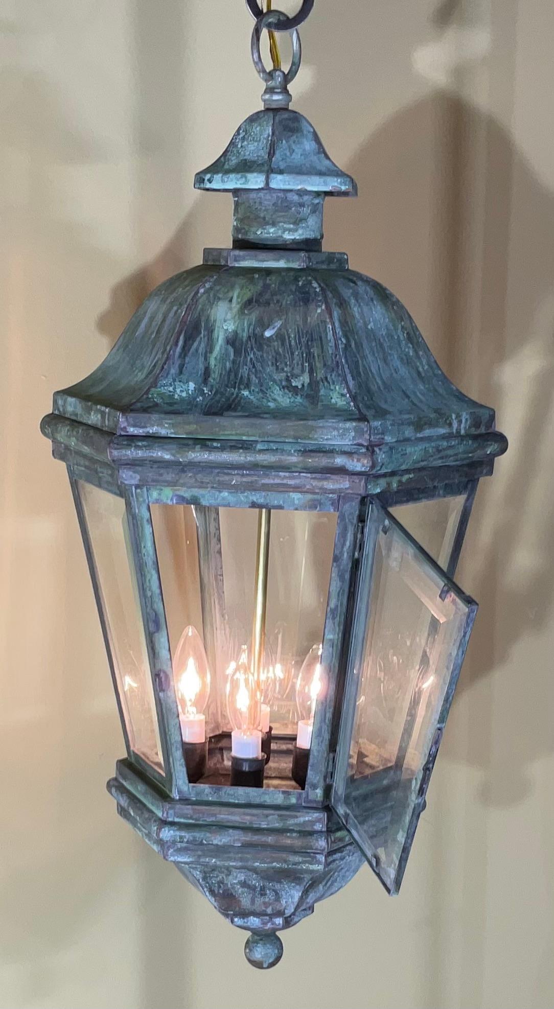 Exceptional six sides hanging lantern made of handcrafted solid brass , clear thick beveled glass, with three 40/watt lights , suitable for wet location
Nice oxidise patina , great look indoor outdoor. 
canopy and chain included.