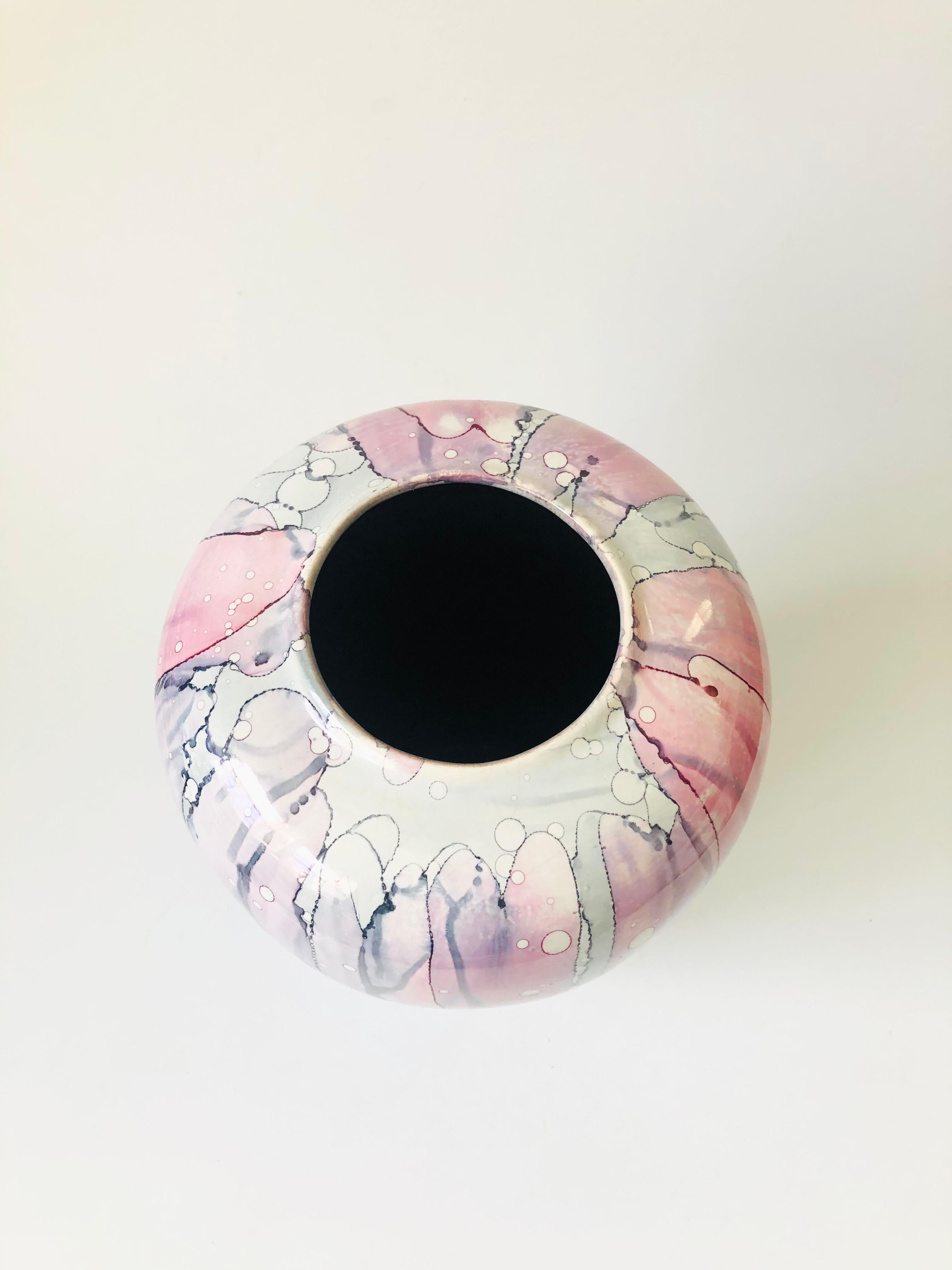 A wonderful vintage handmade pottery vase with a unique drip glaze in purple and pink. Nice size to make a statement.

