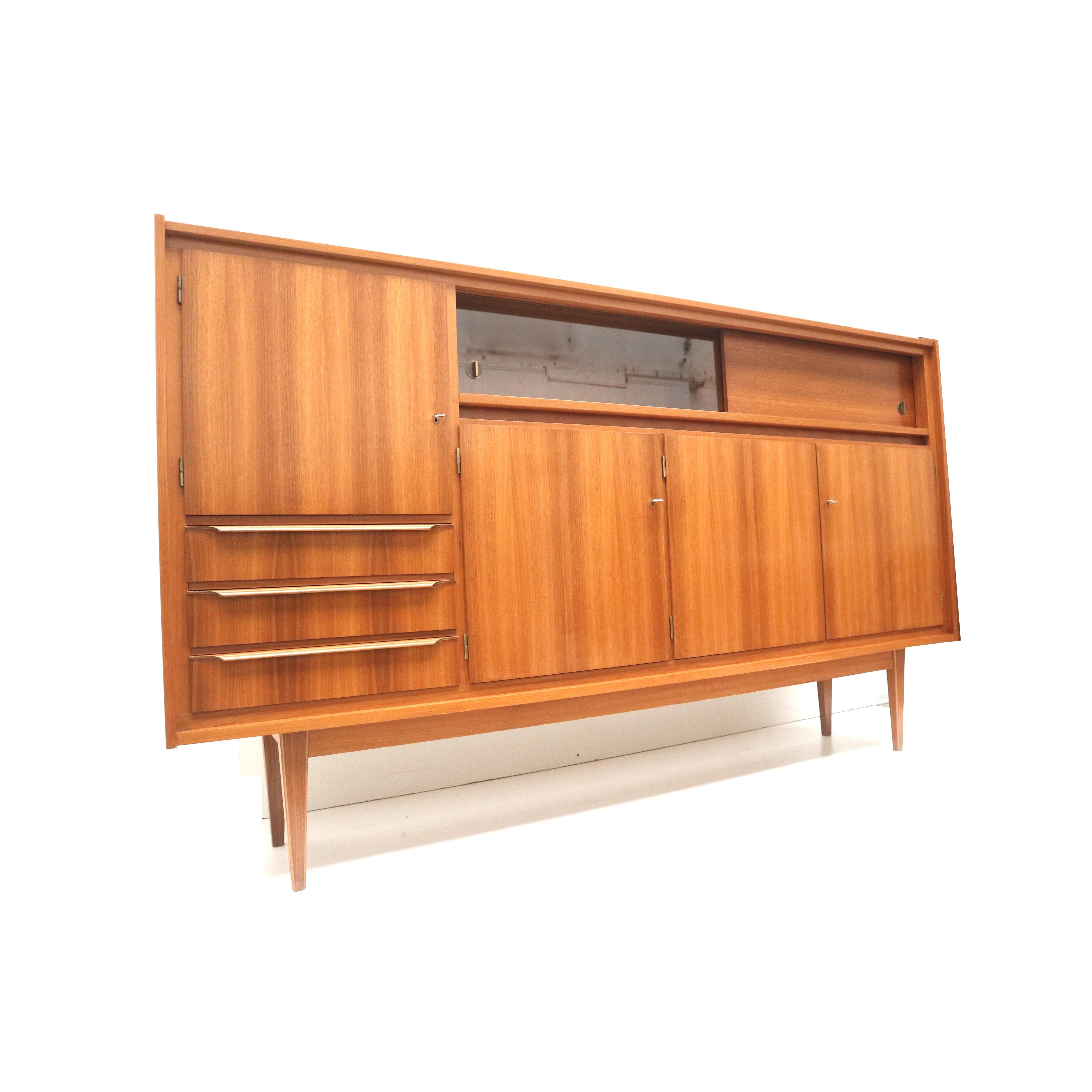 Large vintage high sideboard / highboard made in the 60s.

Dimensions:
Width: 250.3 cm
Height: 146.5 cm
Depth: 44.1 cm