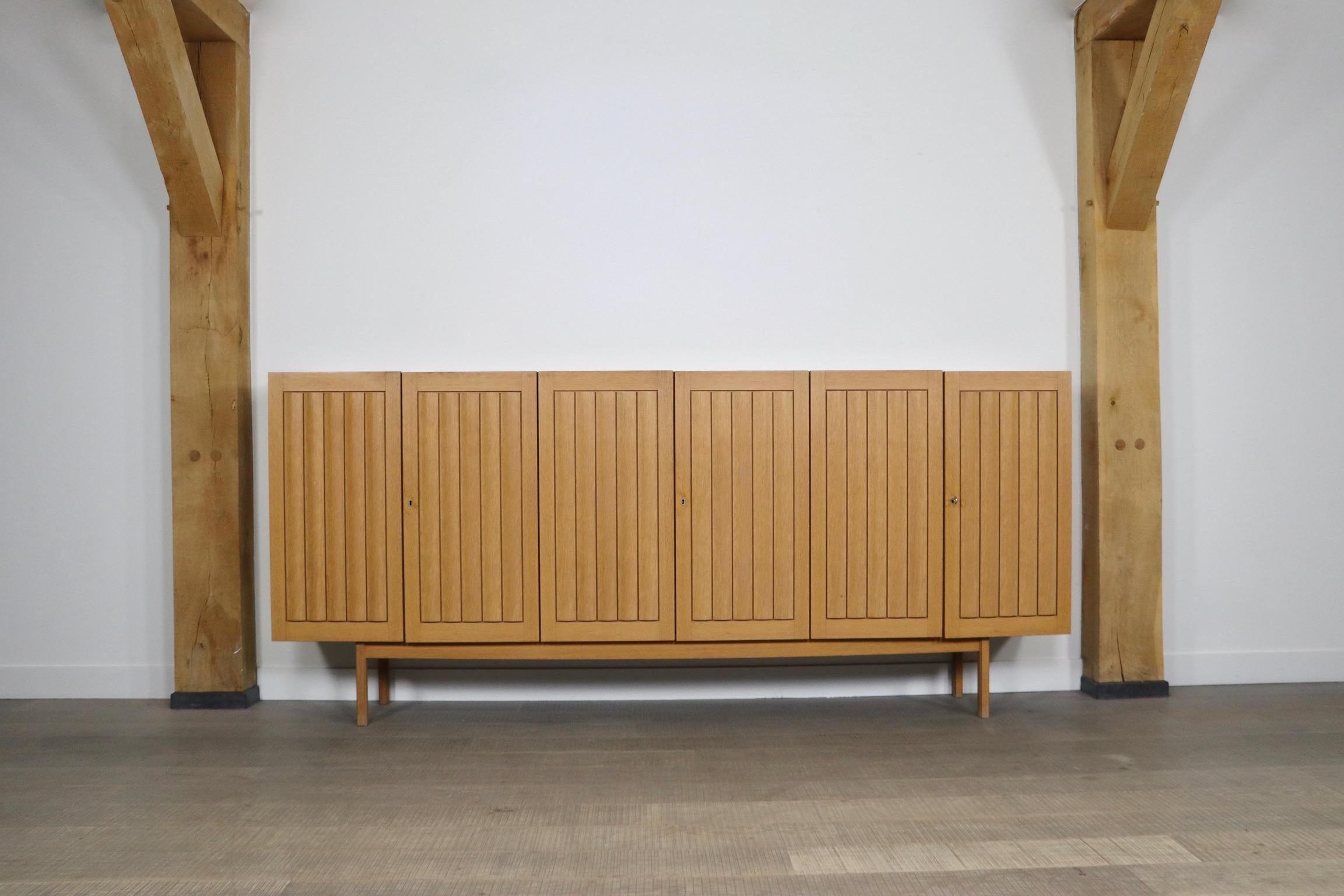 Large vintage highboard in oak by WK Möbel 1960s. With 6 opening doors, 6 shelves and two drawers, this highboard can store a lot! The stunning light oak will fit into any space, bringing warmth and maintaining the calmth. 

Dimensions: W270 x D45