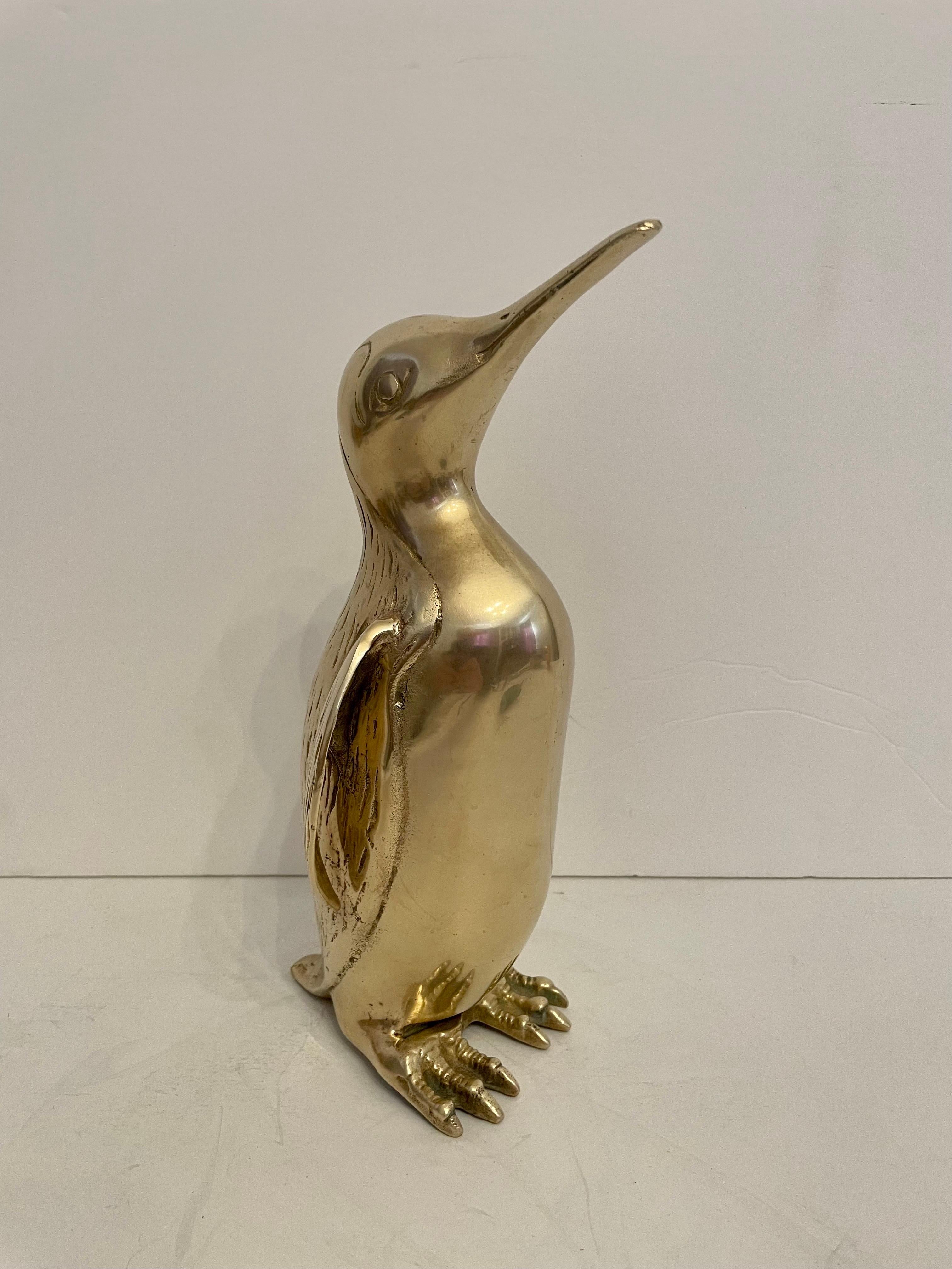  Large Vintage Hollywood Regency brass Penguin sculpture. Nicely detailed. Hand polished. Good overall condition. Dark spots are reflection of light in photos. Measures 10” tall x 5” wide x 5” deep. 