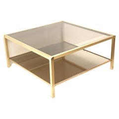 Large vintage Hollywood Regency coffee table made of brass and smoked glass