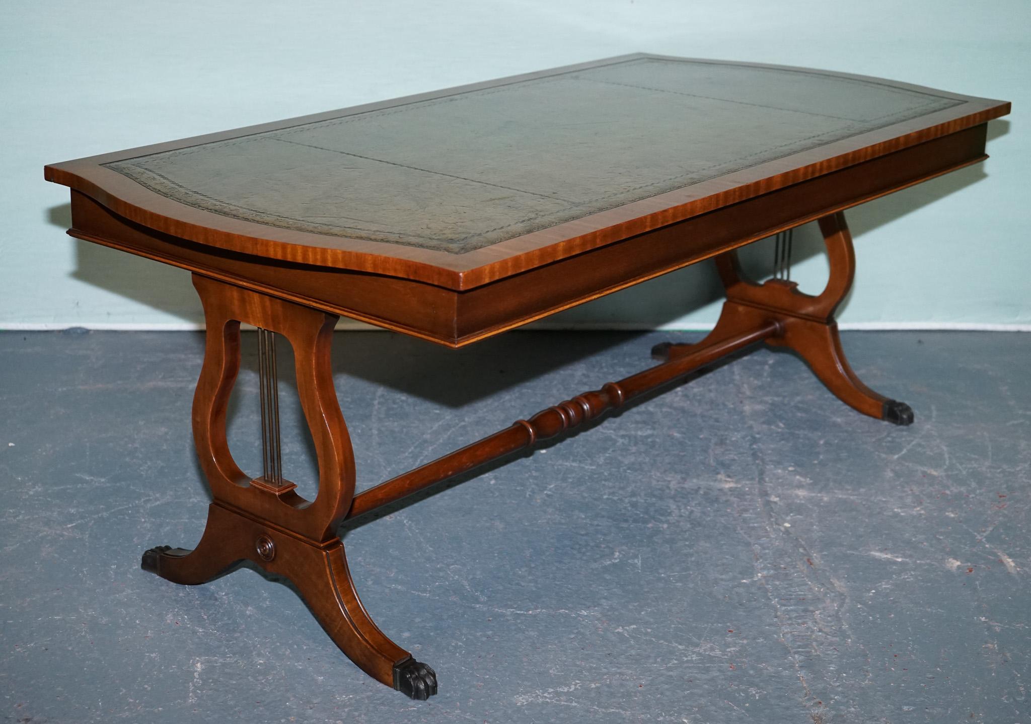 
Antiques of London



This elegant coffee table is crafted from rich hardwood and features a beautifully inset green leather top with gold-embossed tooling. The rectangular top is shaped with gently serpentine sides, adding a refined touch to its