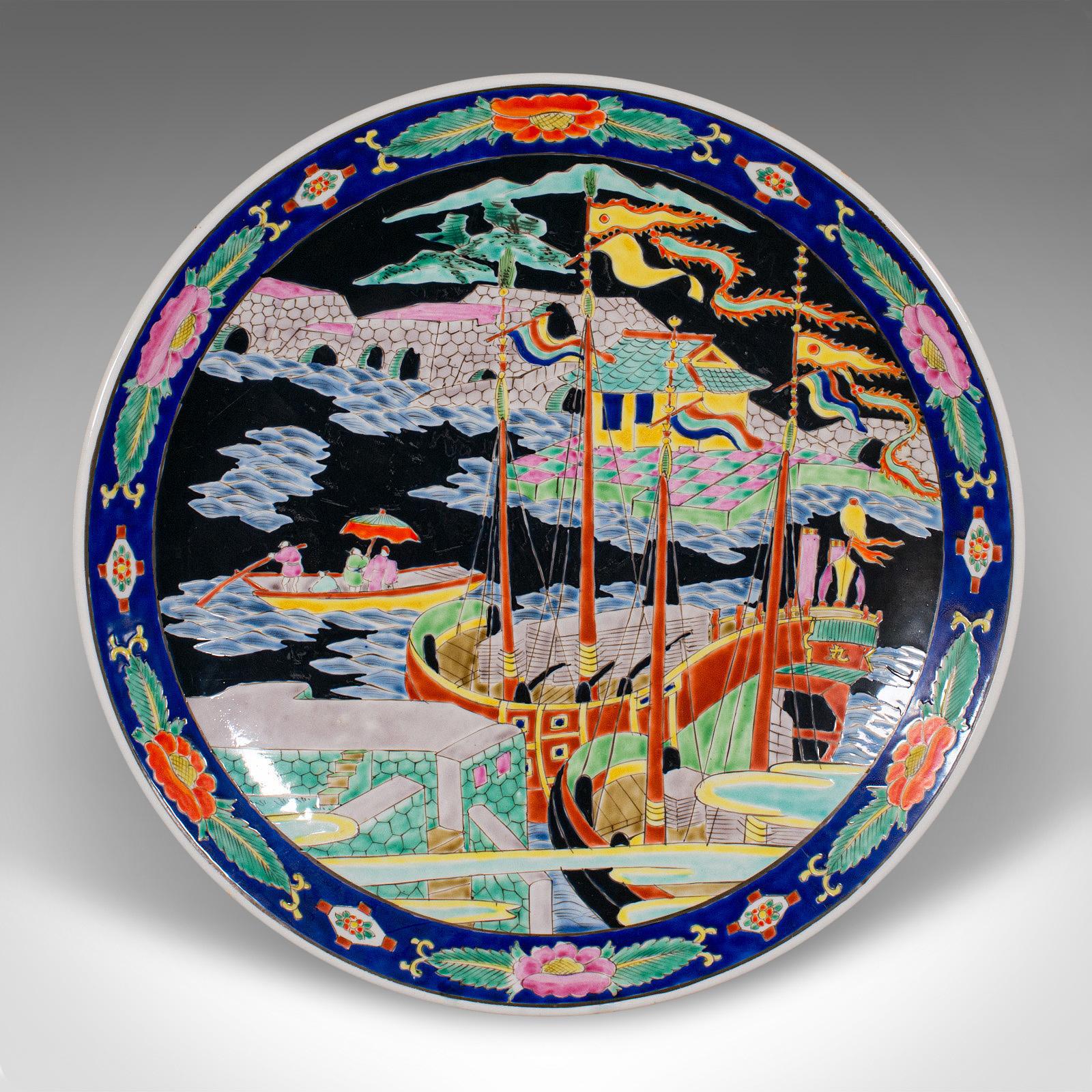 This is a large vintage Imari plate. A Japanese, ceramic decorative charger, dating to the Art Deco period, circa 1930.

Pleasingly vibrant finish across a generously sized plate
Displays a desirable aged patina and in good original order
White