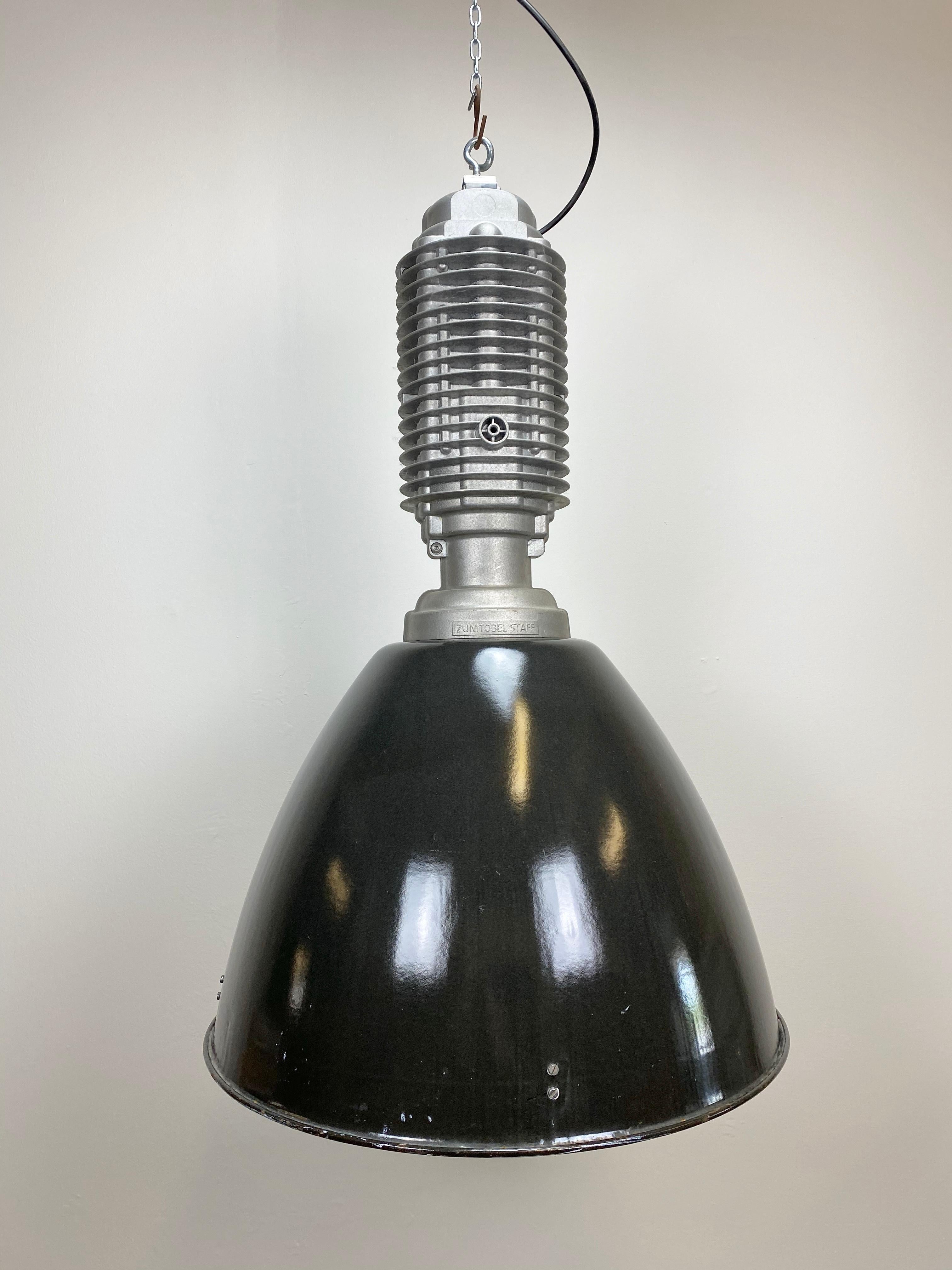 Industrial black enamel hanging lamp. It features cast aluminum top, black enamel shade with white interior, new socket for E 27 light bulbs and new wire. The lamp weighs 8kg.The lampshade diameter is 53 cm.