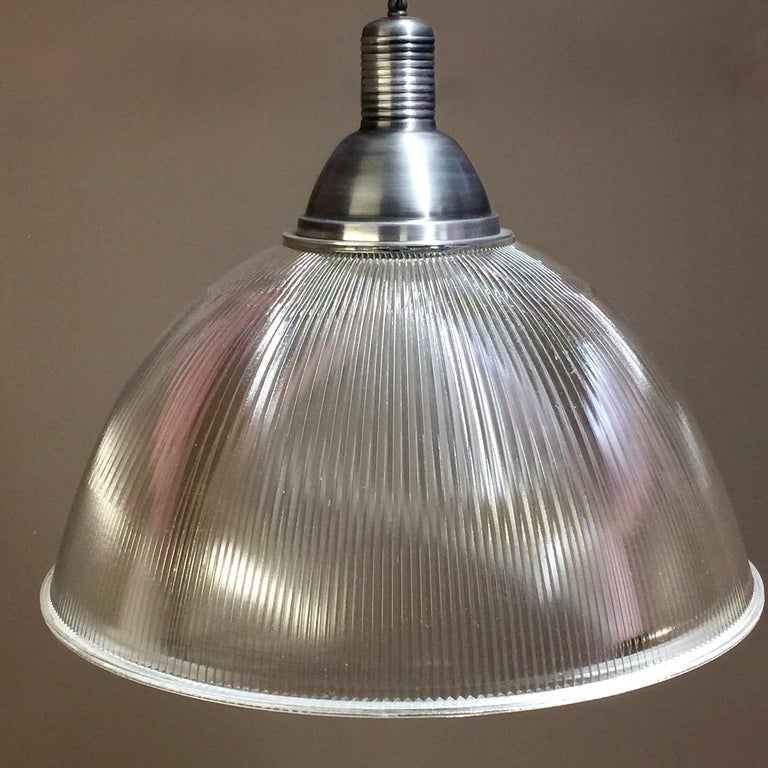 These beautiful vintage commercial grade Holophane ceiling lights are a design Classic. Reclaimed from a factory, repolished and rewired. We have around 50-60 left. They are 21.25 inches in diameter with a 20-inch drop from the bottom of the shade