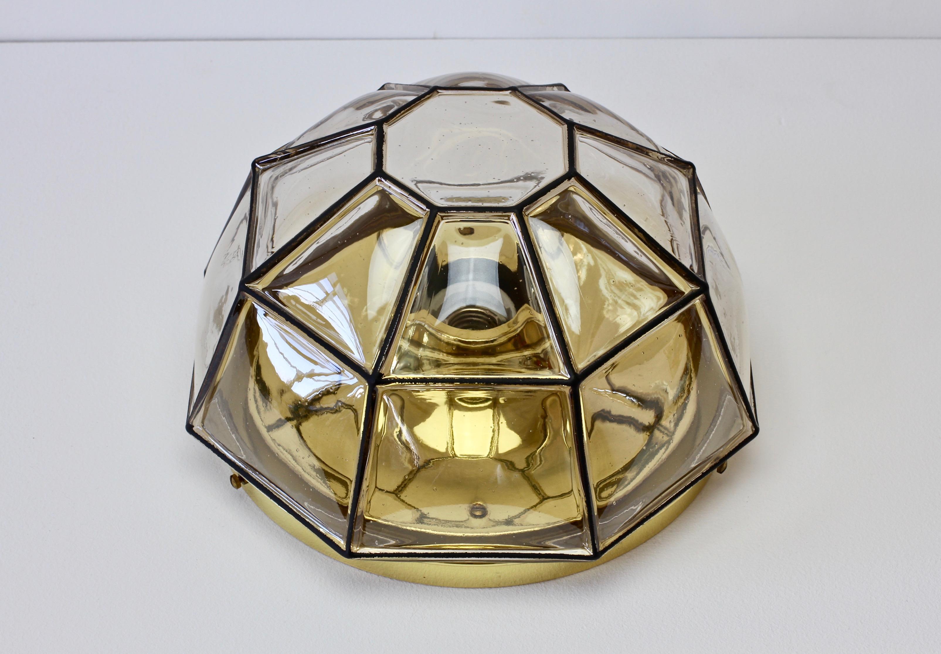 Glashütte Limburg minimal, geometric and elegant clear glass and polished brass wall or ceiling flush mount lamp / light fixture made in Germany, circa 1965. The clear 'bubble' glass - held in place with solid polished brass hardware - bulges