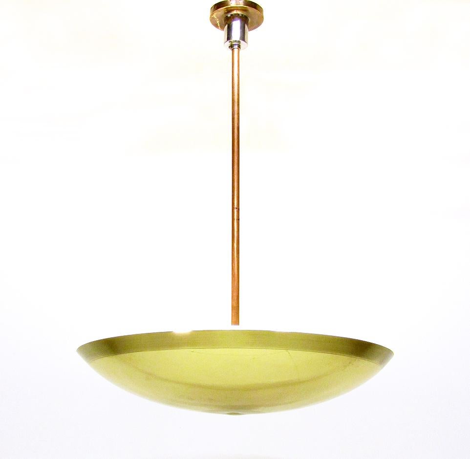A large and opulent Italian Art Deco chandelier attributed to Pietro Chiesa for Fontana Arte.

In beautiful bright brass with copper stem and glass diffuser, this original 1930s uplighter would make an impressive centrepiece.

The matt glass