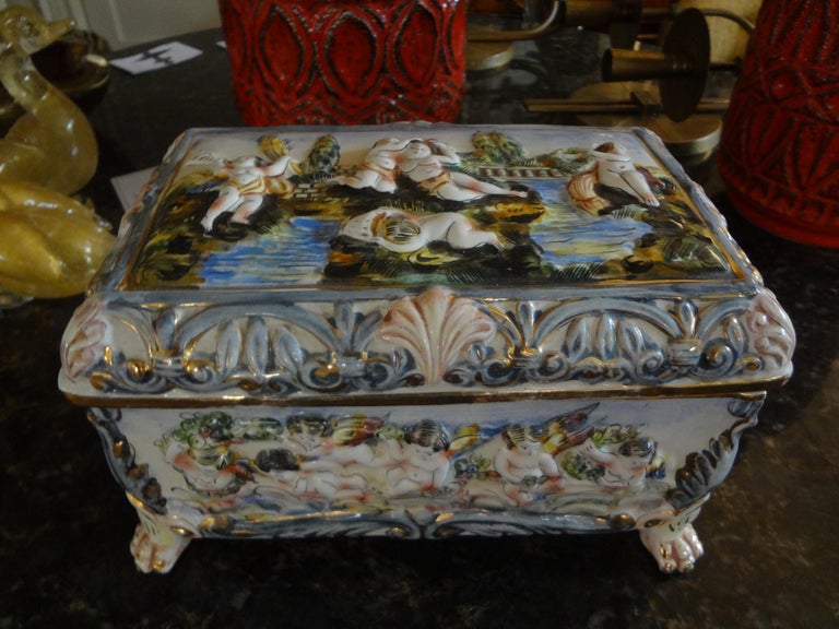 Large vintage Italian Capodimonte Porcelain box.
Stunning large vintage Italian Capodimonte porcelain box. This lovely Italian Capodimonte decorative box, jewel casket, or jewelry box is hand decorated in an unusual color palette with raised