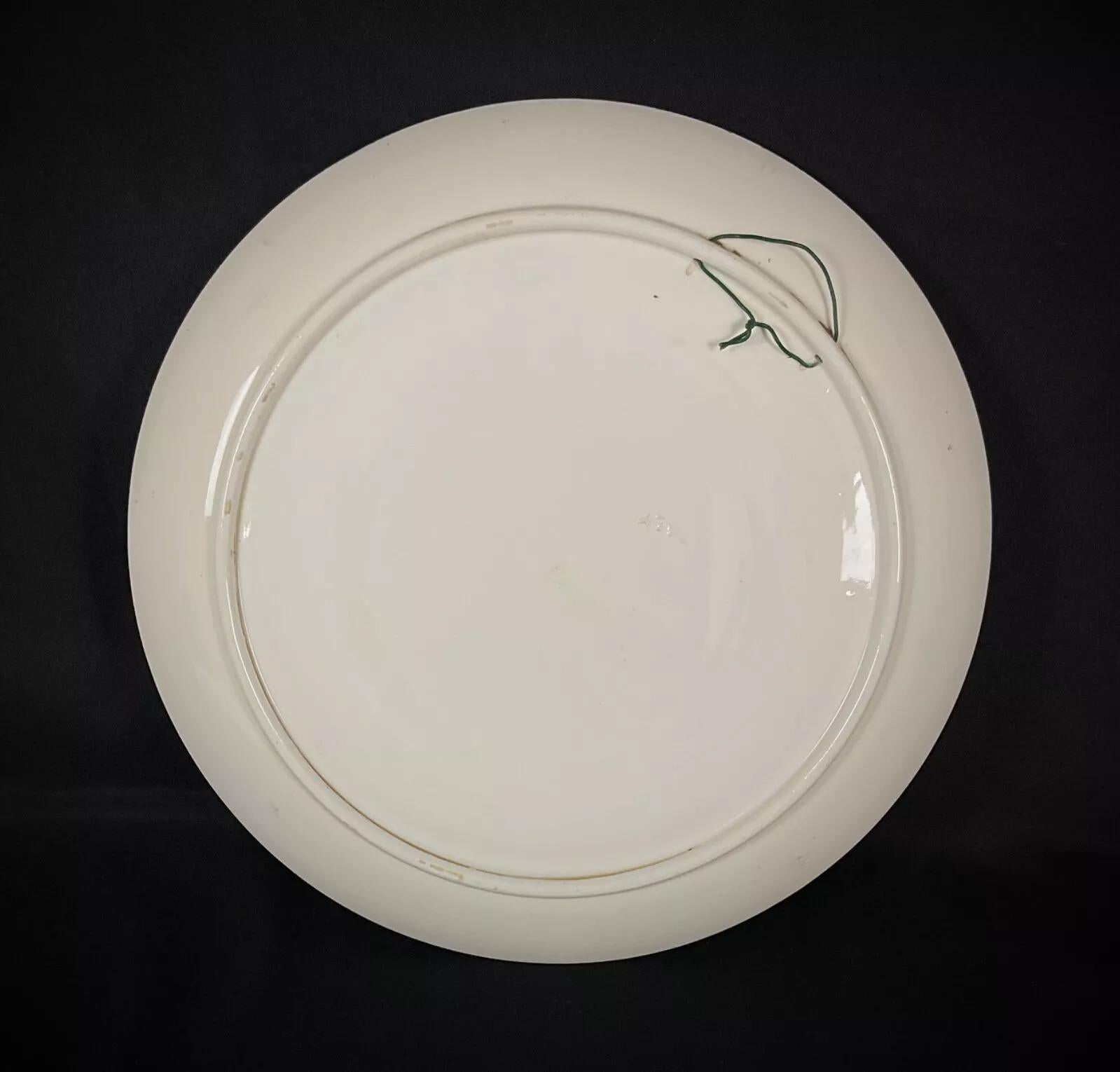 This large vintage Italian ceramic plate showcases a beautifully detailed hunting scene featuring a pheasant, surrounded by an arrangement of fruits. The hand-painted design and rich, earthy tones make this a stunning decorative display piece for