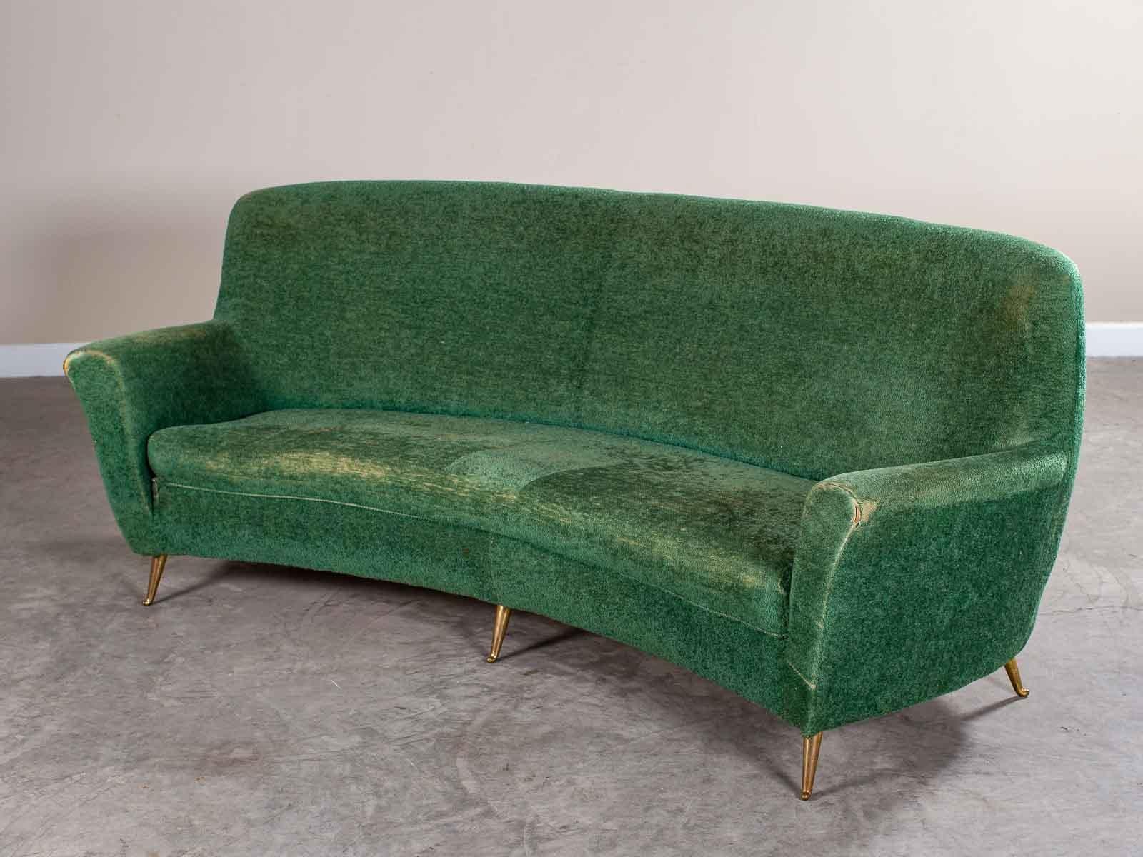The well known Italian manufacturing firm ISA made this sofa with its distinctive curved shape. This exceptional vintage Italian sofa by ISA Bergamo has the original green upholstery. Please notice the unusual curved profile of the sofa with its