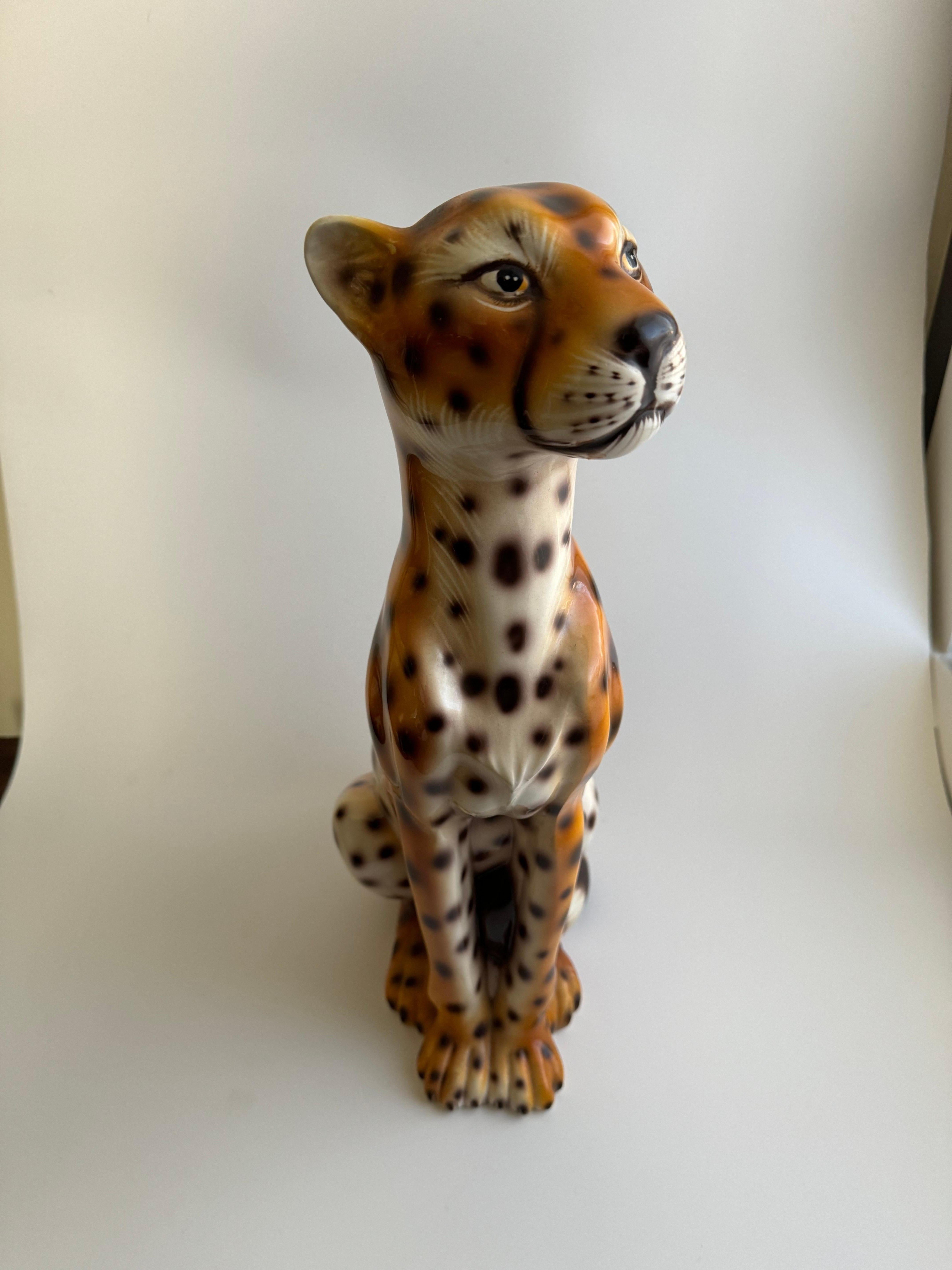 Vintage Italian porcelain leopard statue.The craftsmanship highlights the leopard’s spotted coat and muscular build, capturing its essence in a stylized manner. Vintage Italian porcelain often reflects a high level of detail and artistry, which is