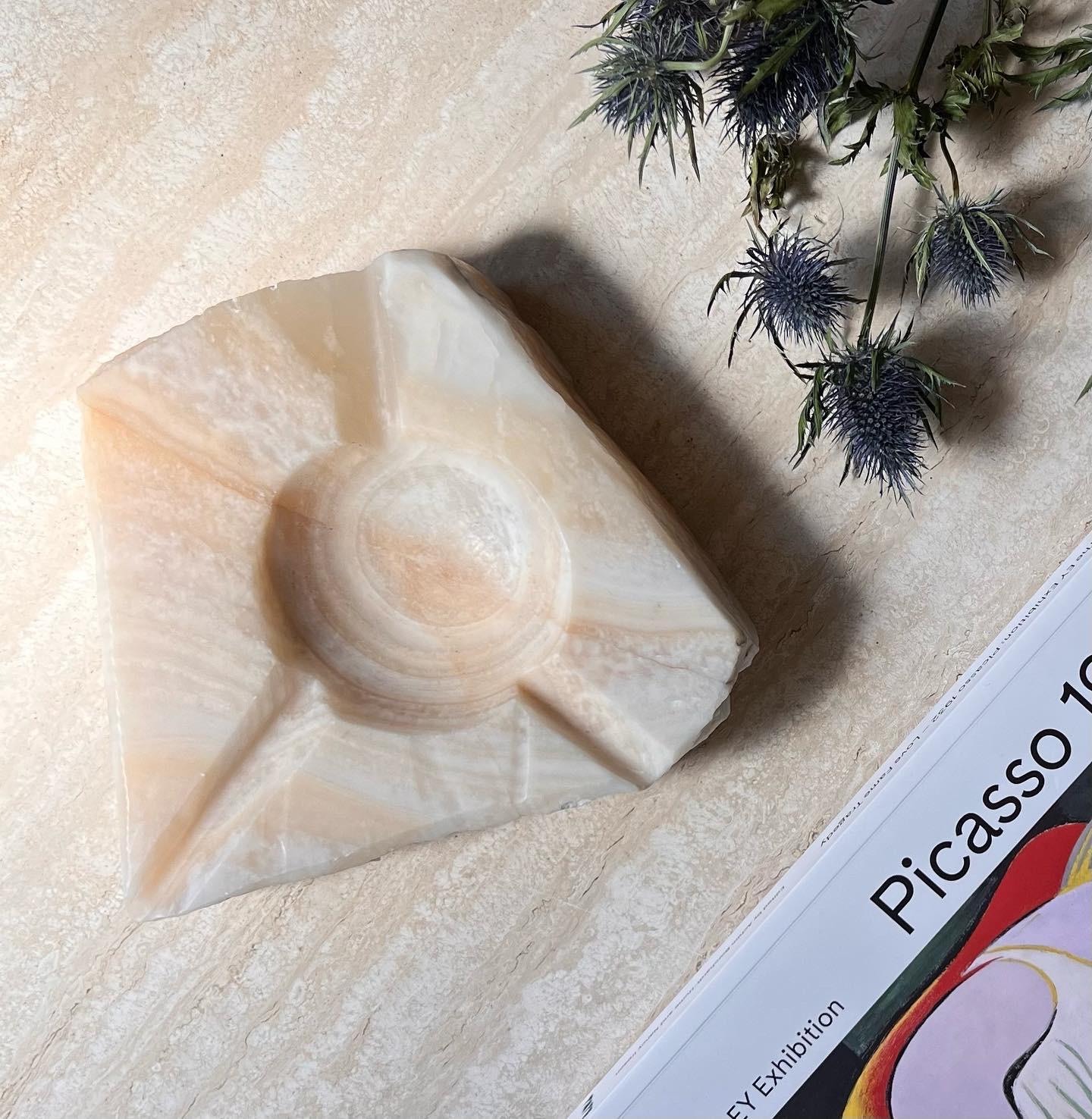 A monumental vintage Italian raw travertine slab ashtray, circa 1960s. hand carved and featuring three chunky rivulets. Tones of crème brûlée and pearl. Pick up in central west Los Angeles or worldwide shipping available.
Dimensions:
8” W x 7.5” D