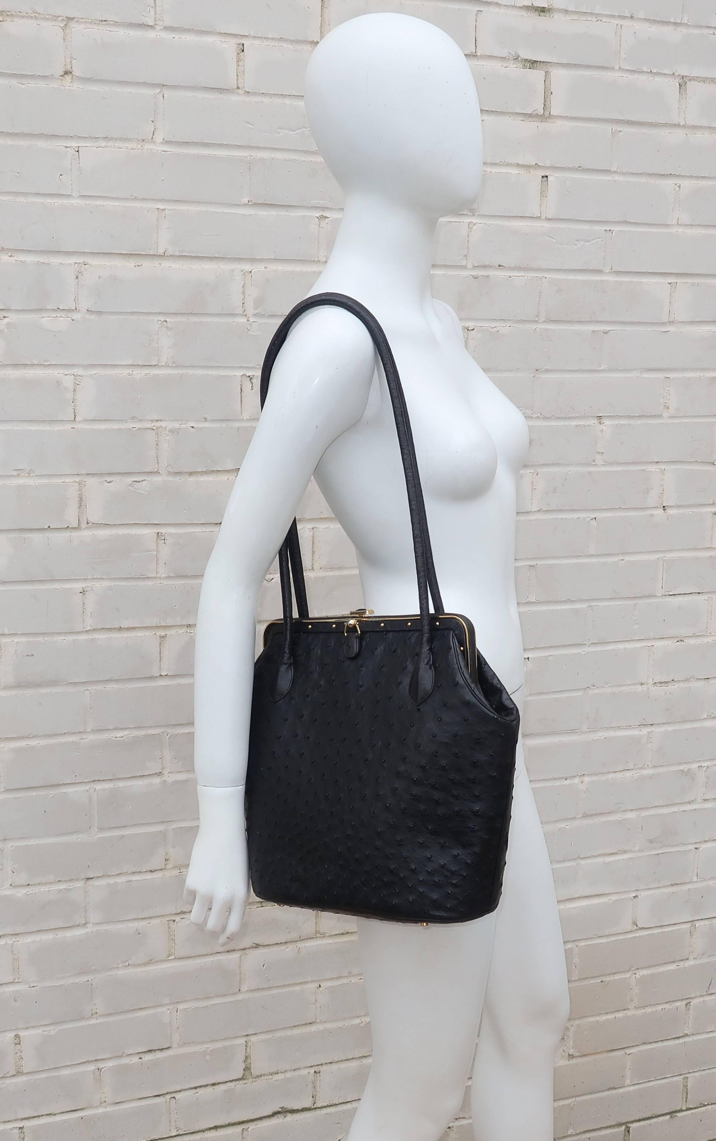 This fabulous Judith Leiber black ostrich handbag is both uncharacteristically large and a little edgy for the designer.  The body of the handbag measures 14.5