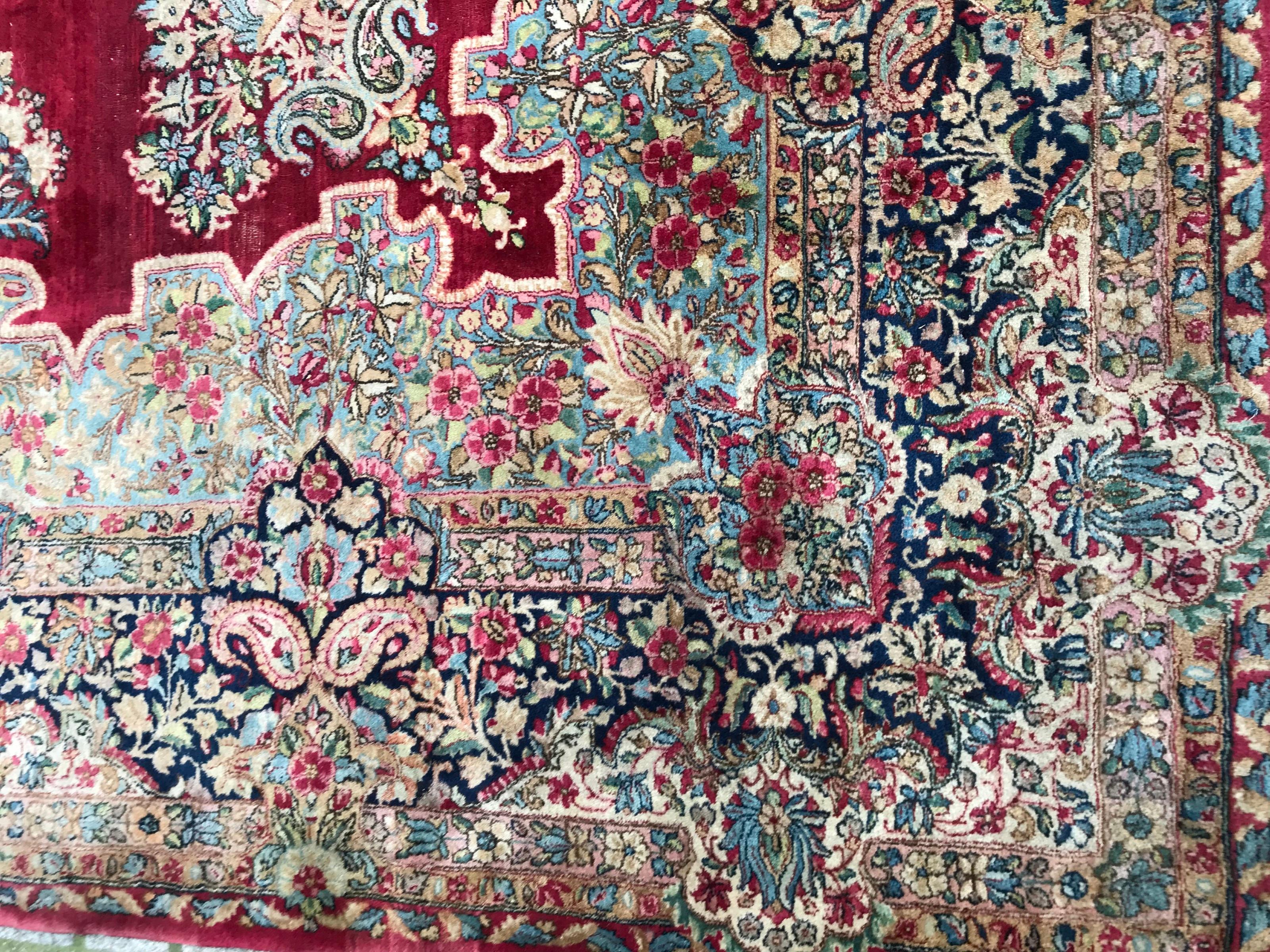 Beautiful mid-20th century very fine large rug with a beautiful floral Savonnerie design with a central medallion and nice colors with red field and blue, pink, yellow and green, finely hand knotted with wool velvet on cotton foundation.