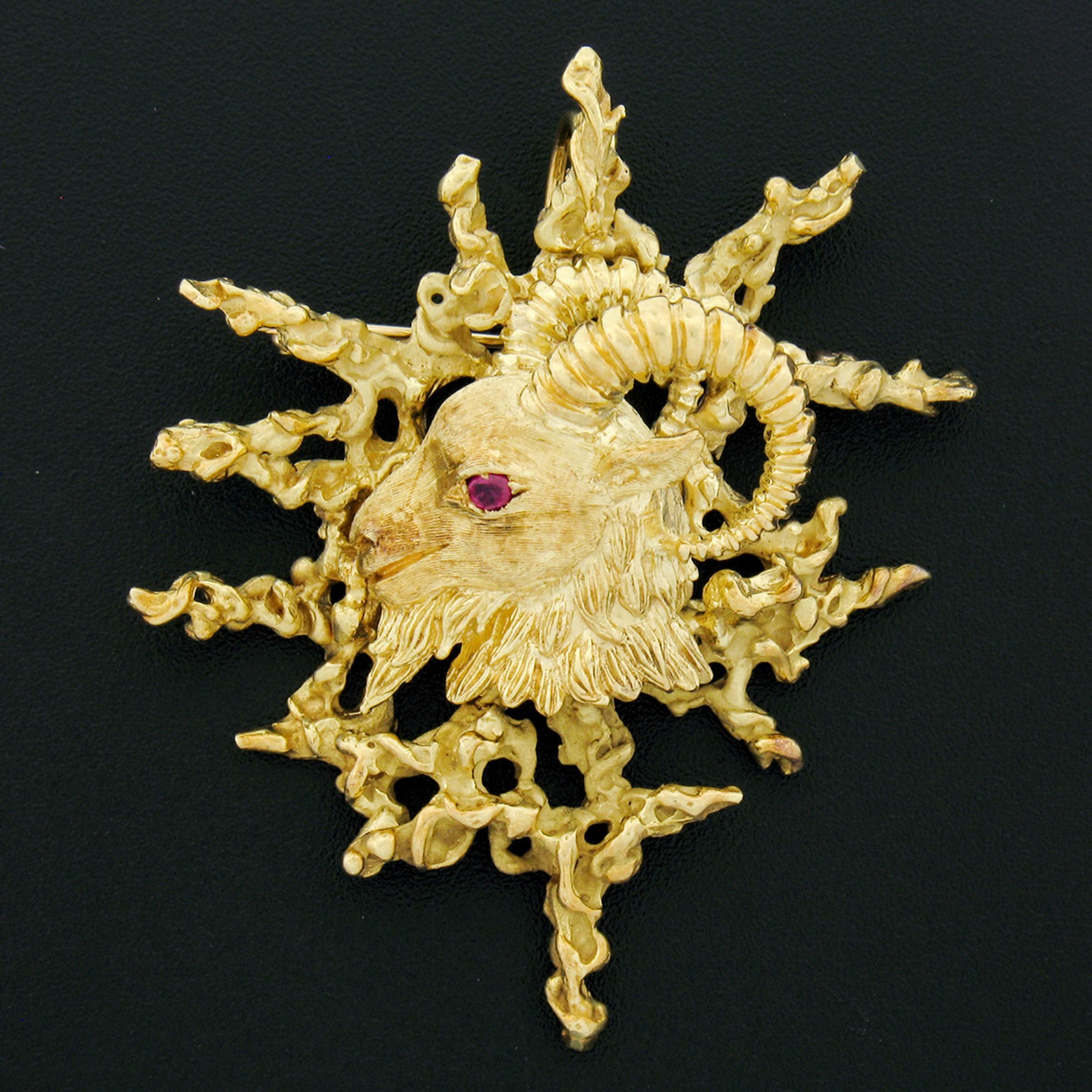 Here we have a magnificent, vintage, Kurt Wayne pin/brooch or pendant that was crafted in 1969 from solid 18k yellow gold. This substantial piece features an incredibly detailed design with a ram at its center in which has a fine ruby neatly set at