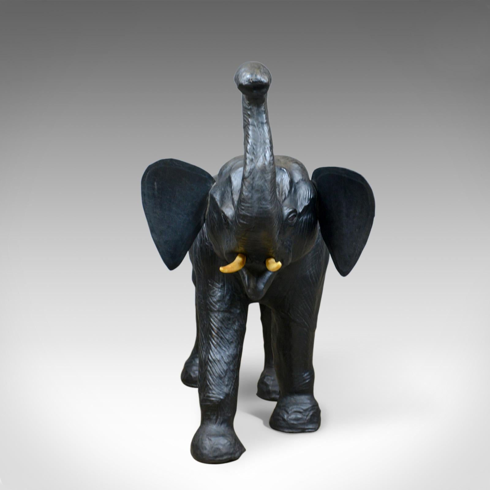 This is a large, vintage leather elephant sculpture. A three foot tall, at trunk (72cm to back) striding elephant model dating to the mid-20th century.

Superbly modelled and detailed sculpture
In a quality black leather hide with a desirable