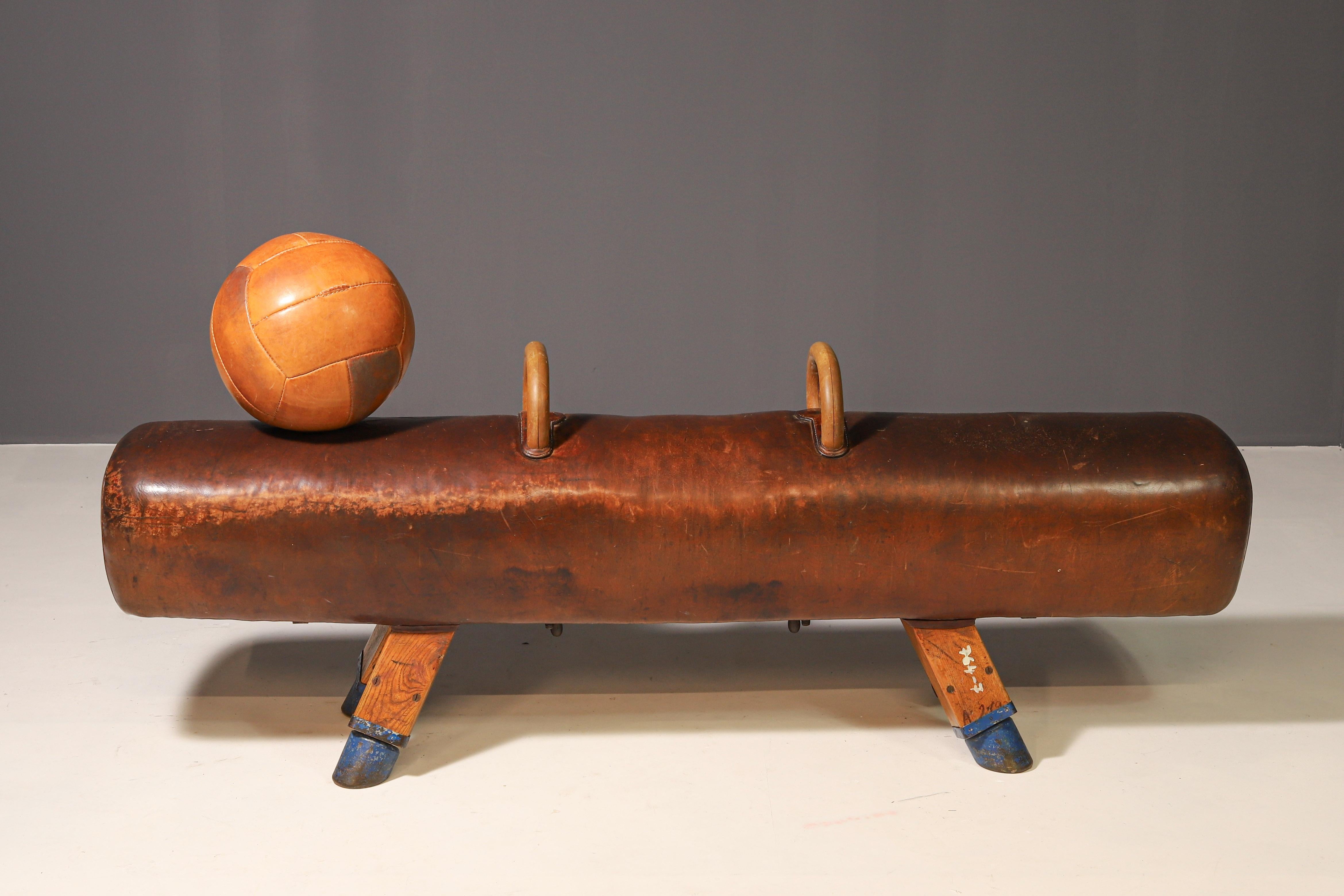 This vintage leather medicine ball is made of thick, high-quality leather with a beautiful patina. It remains firm, in good condition, and fully functional.

There are some original markings on the surface, adding to its authenticity as a historical