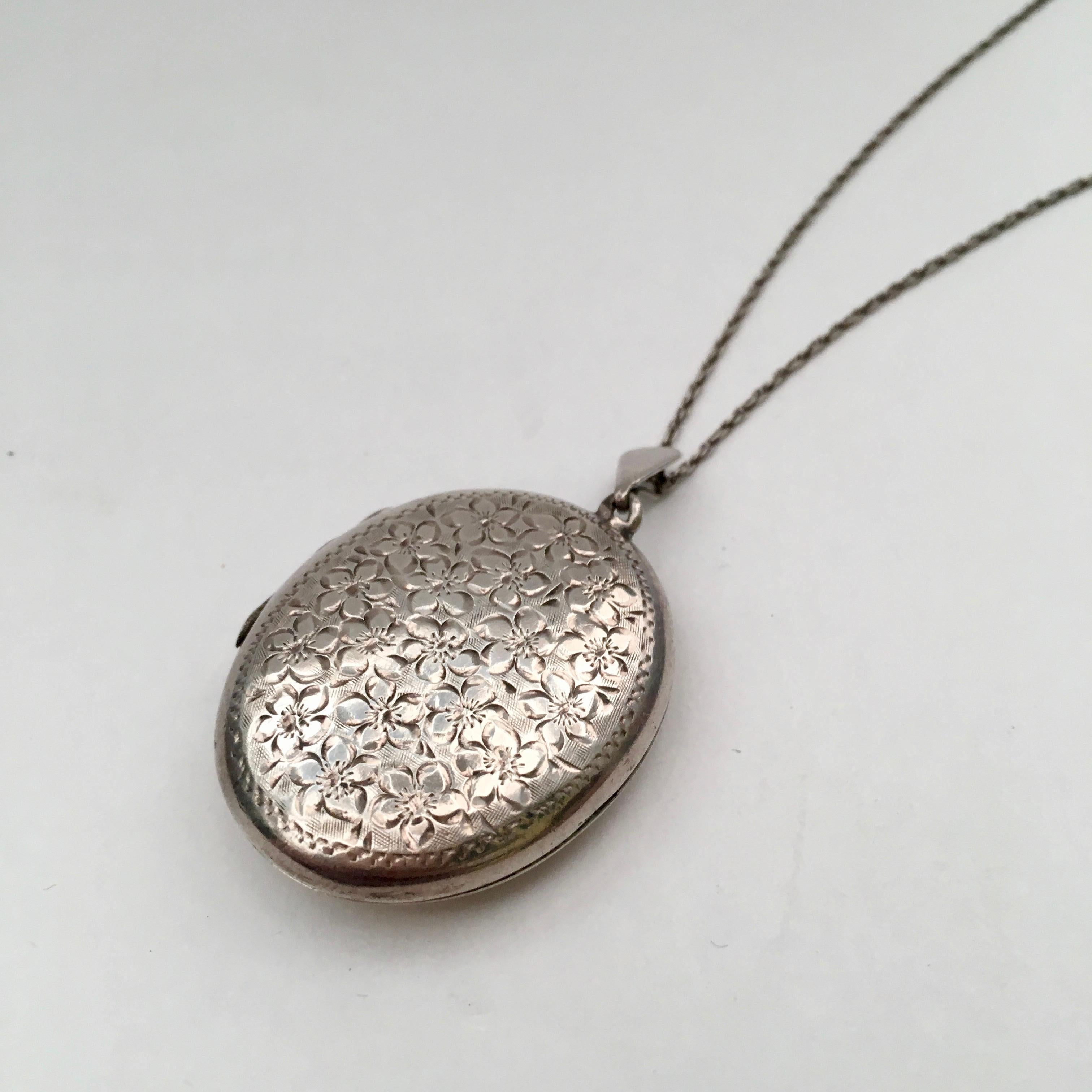 A beautiful classic, this large sterling silver locket is engraved with delicate flowers. The generous proportions mean it could easily hold photos of a loved one, a lock of hair, or even a dried flower. The locket is 3.3cm tall (4.2cm including the