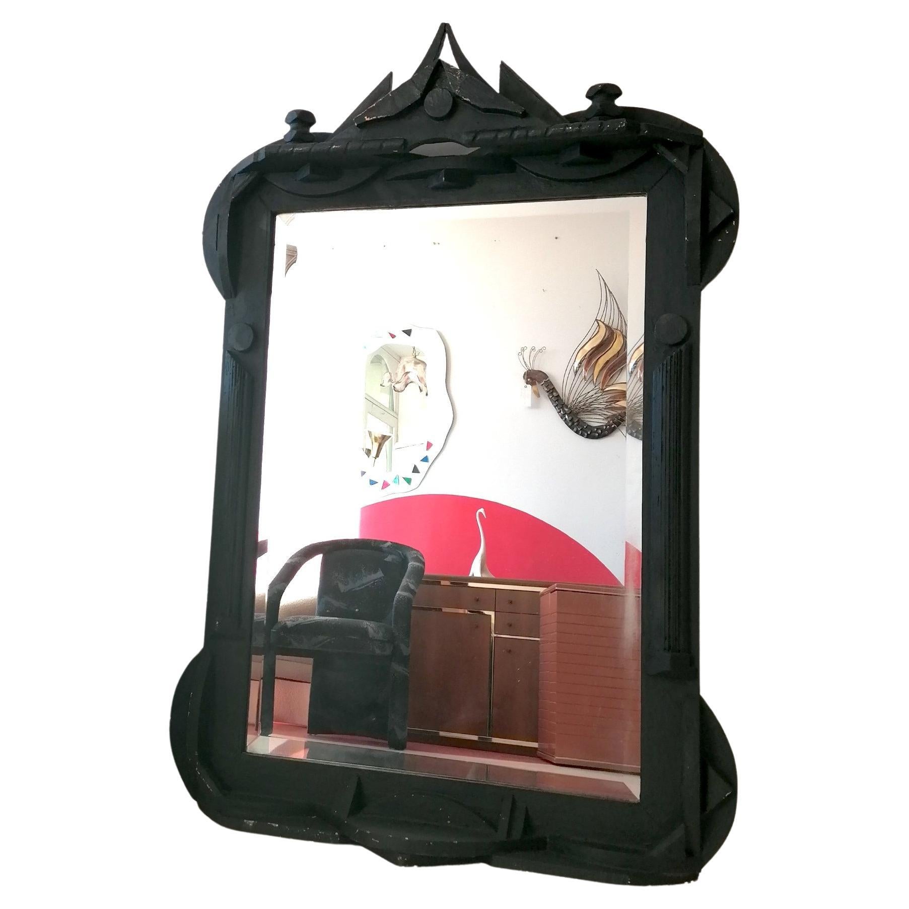 A large Louise Nevelson style brutalist mirror, USA c1960s.
Black-painted wood (some wear, showing gold beneath). Bevelled mirror glass.
There's a hanger on the reverse, or it can be used as a floor-standing mirror.
Dimensions : height 142cm,