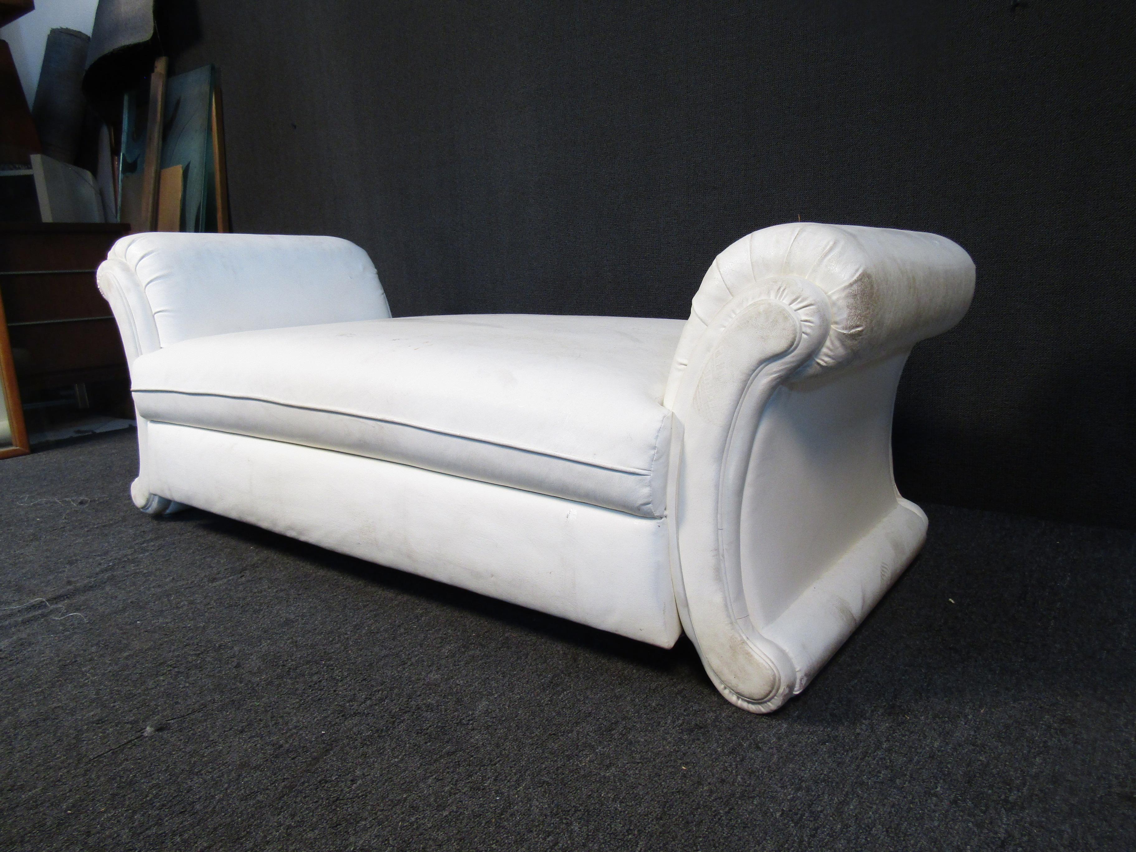 This large and unique white loveseat features curving arms and white vinyl upholstery. Please confirm item location with seller (NY/NJ).