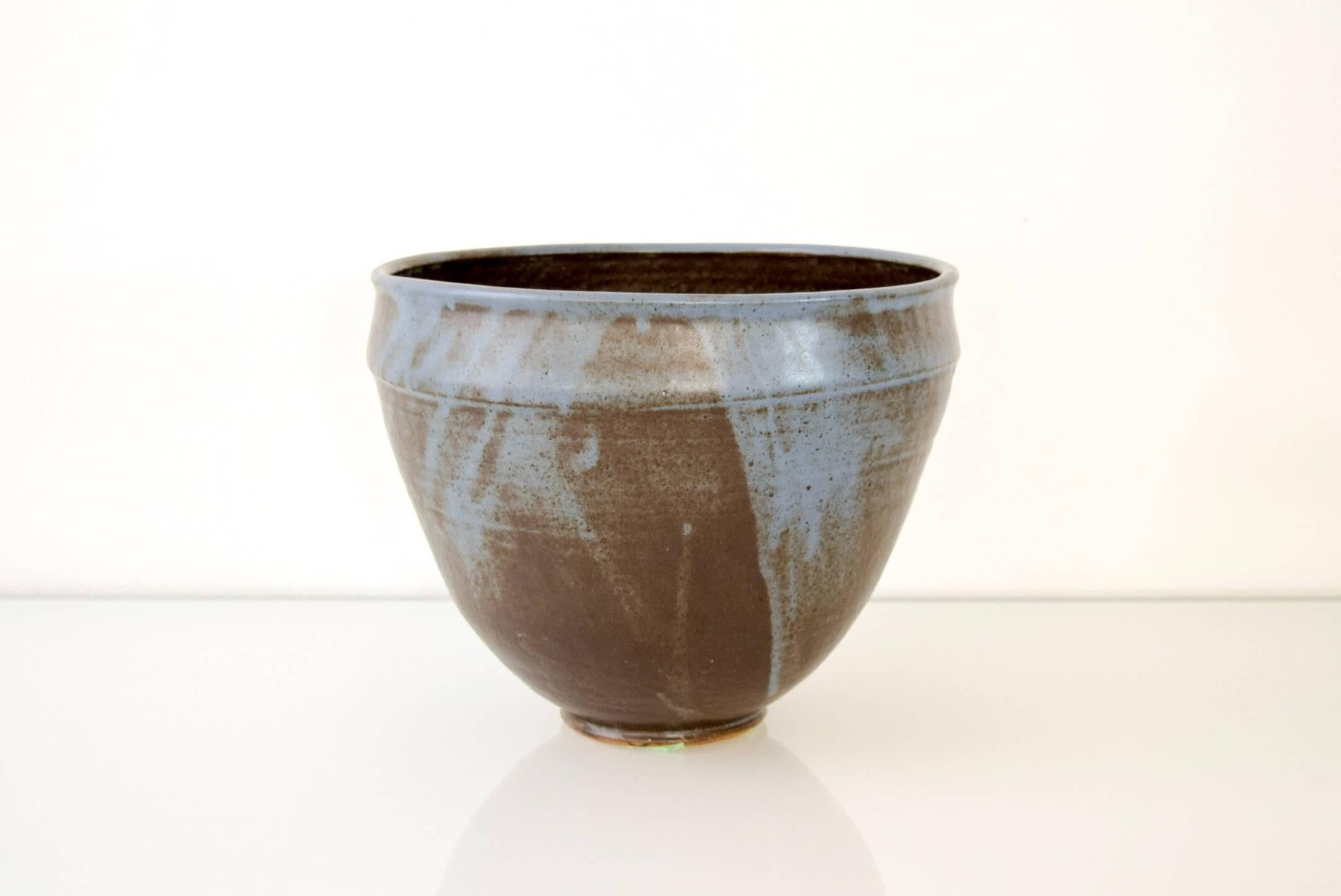 This large vintage Mid-Century Modern decorative ceramic pottery bowl is circa 1960. It was handcrafted and features a simple modernist design with a tall proportion and gorgeous blue tones.

Dimensions:
Diameter 9 3/4