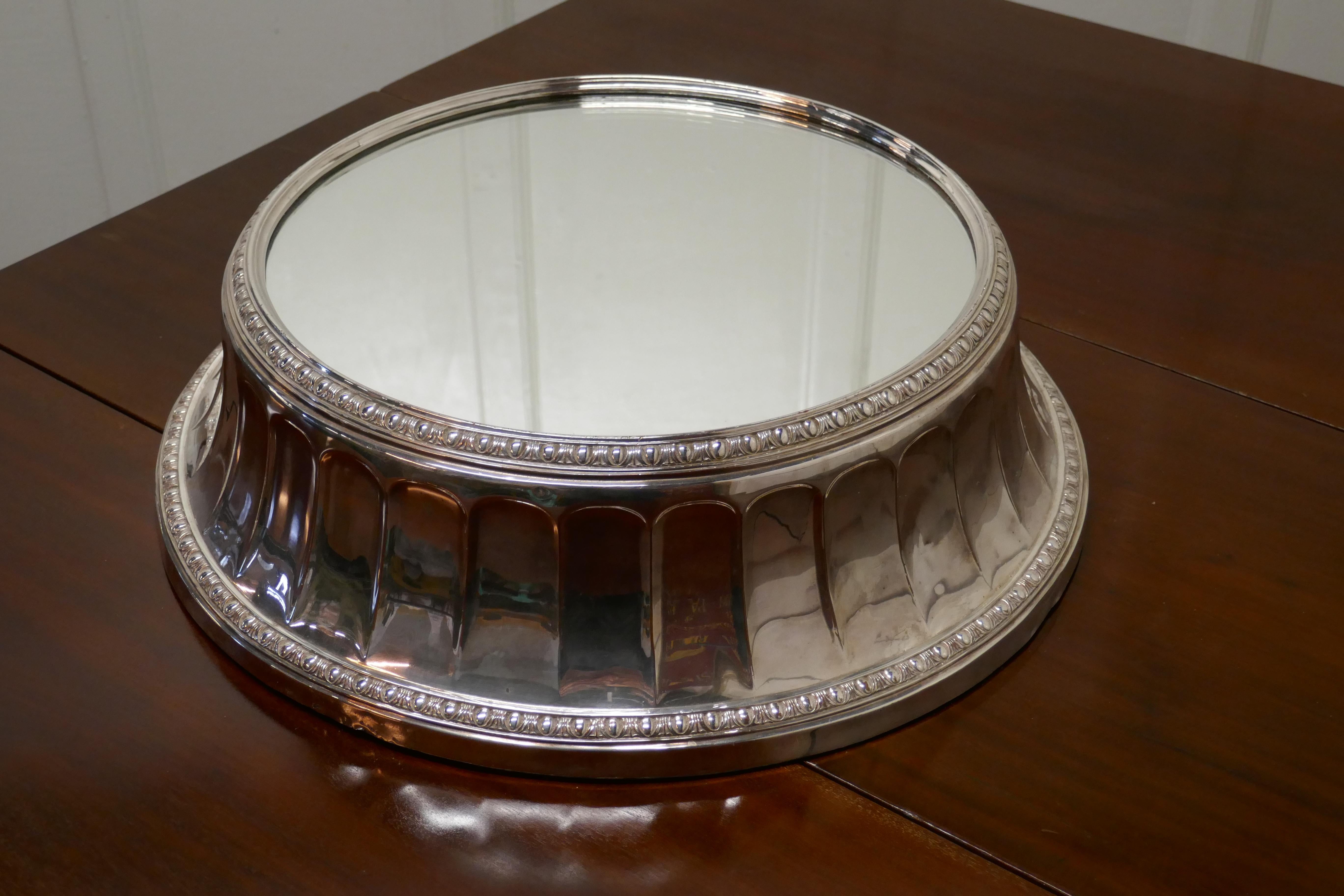 Large vintage mirror top Elkington silver plate wedding cake stand

This beautiful piece from Elkington & Co, a sure sign of top quality, the stand is 6” high with mirror top plate
The stand has a wide fluted side, and will take a cake up to 14”