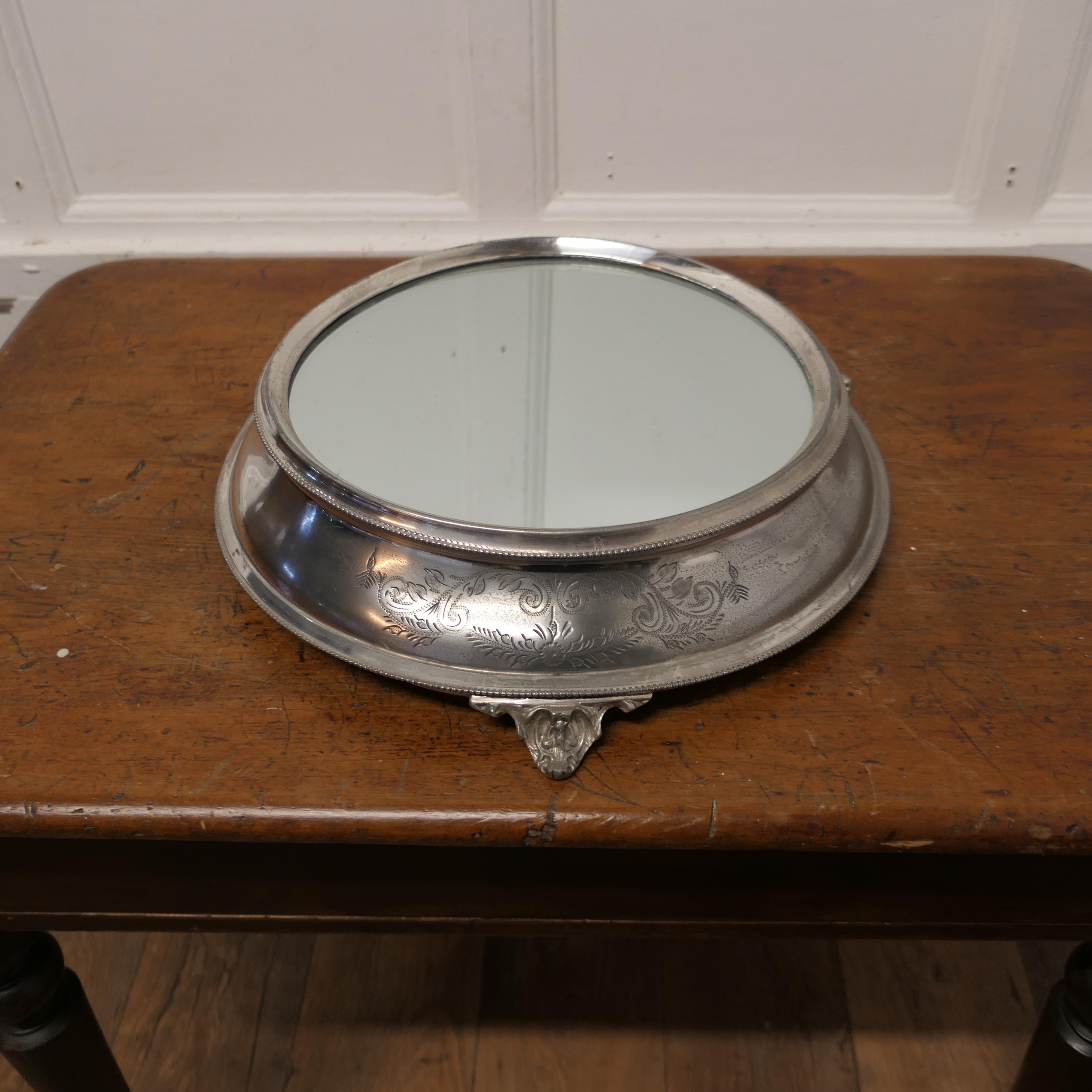 Large Vintage Mirror Top Silver Plate Christmas Cake Stand

This is a beautiful piece, the stand is 4” high with a mirror top plate
The Stand has a wide etched shaped side with feet beneath, and will take a cake up to 12” across, the diameter of the