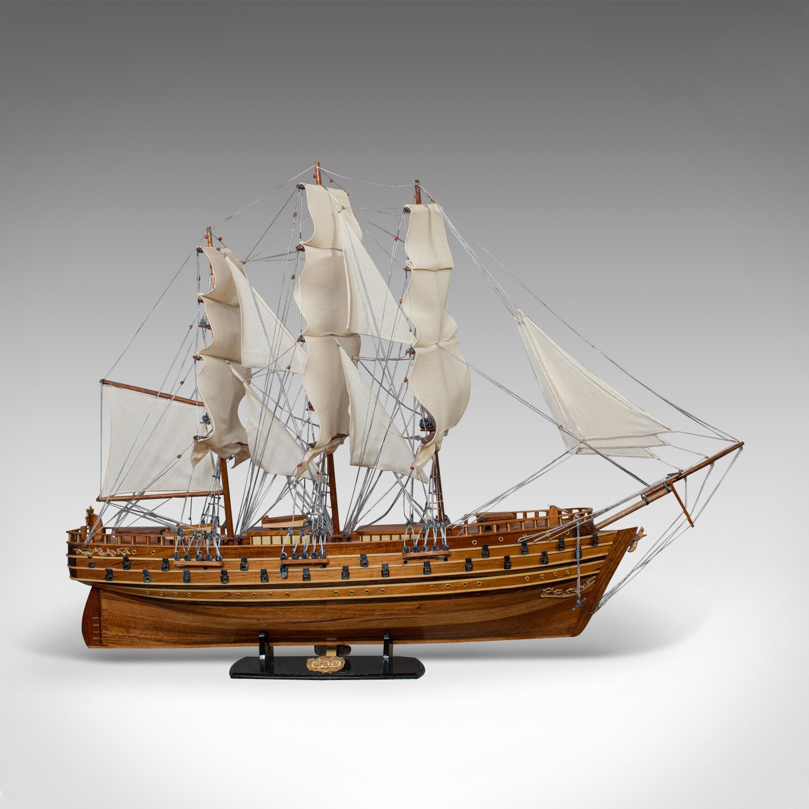 This is a large vintage model ship 'Napoleon'. An English, mahogany collectible ship with display stand and dating to the 20th century.

A model of a full-rigged ship named in honour of Napoleon Bonaparte, emperor of France.

Fine detail and in