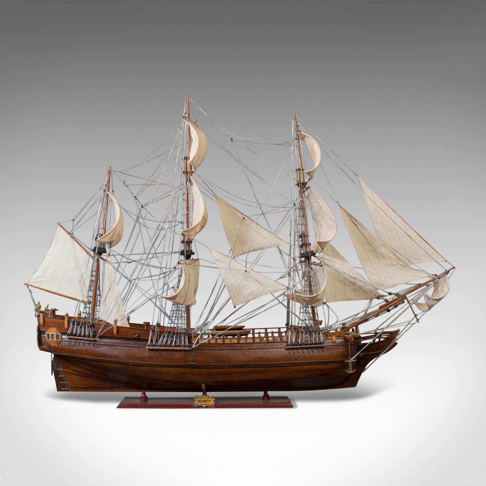 This is a large vintage model of the Bounty. An English, mahogany collectible model ship on display stand and dating to the 20th century.

The Bounty was purchased by the Royal Navy to transport plants around the Caribbean islands. Under the