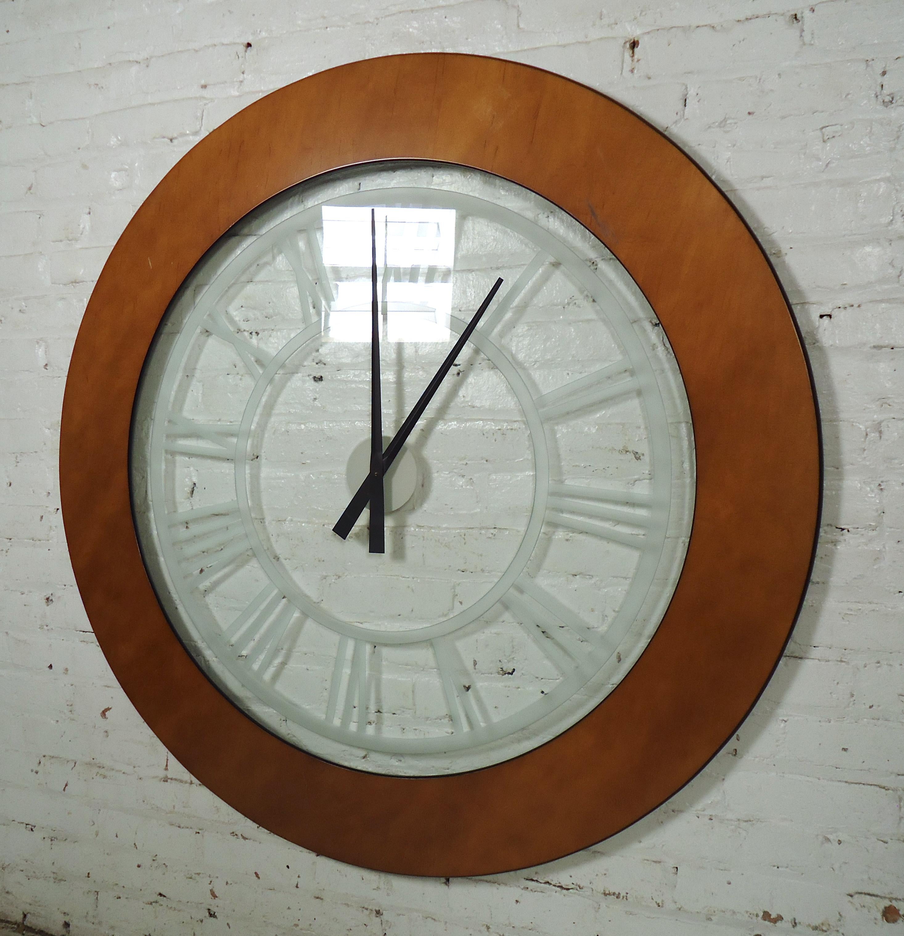 Mid-Century Modern style wall clock features a large transparent center with a wood veneer frame.

(Please confirm item location - NY or NJ - with dealer).