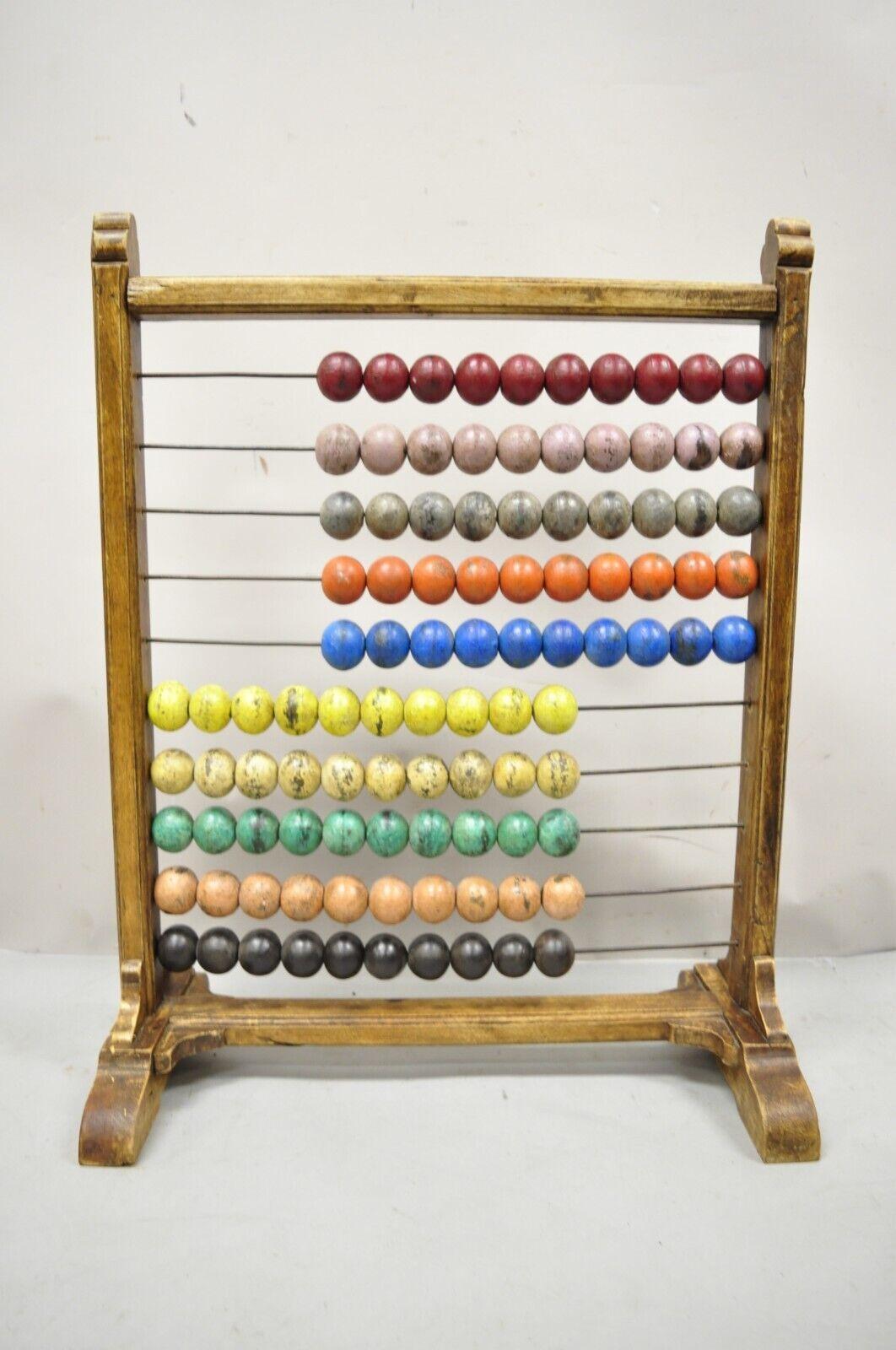 Large Vintage Mongolian Wooden Math Abacus with Painted Wooden Balls. Item features painted wooden balls in red, purple, gray, orange, blue, yellow, green and brown. Circa Mid 20th Century, possibly older (age undetermined). 
Measurements: 29
