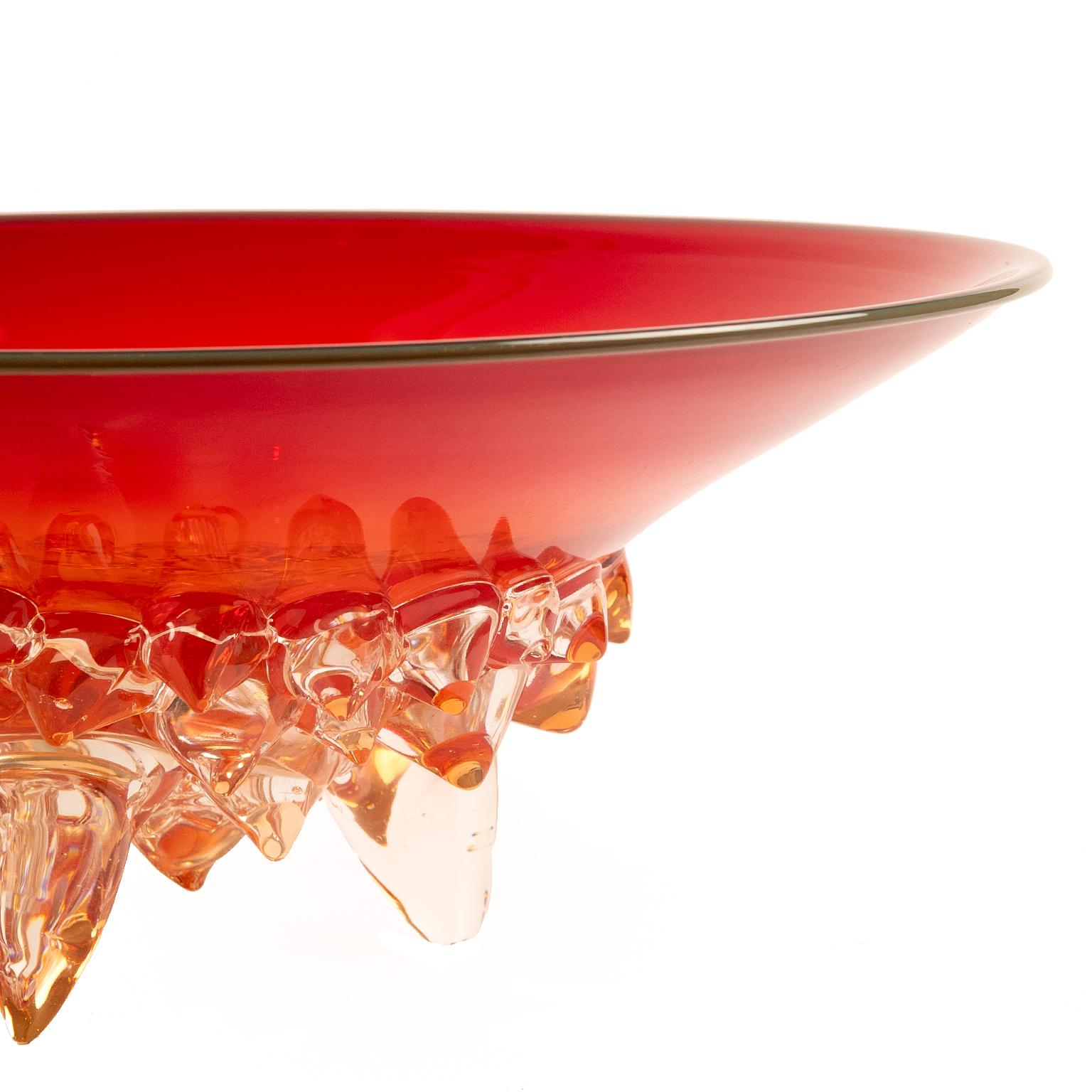 Wow! A stunning large art glass bowl or center piece in vibrant multi dimensional red with clear Restrato style
design underneath decorating and supporting the bowl. It is signed (see photo) and dated 2000.