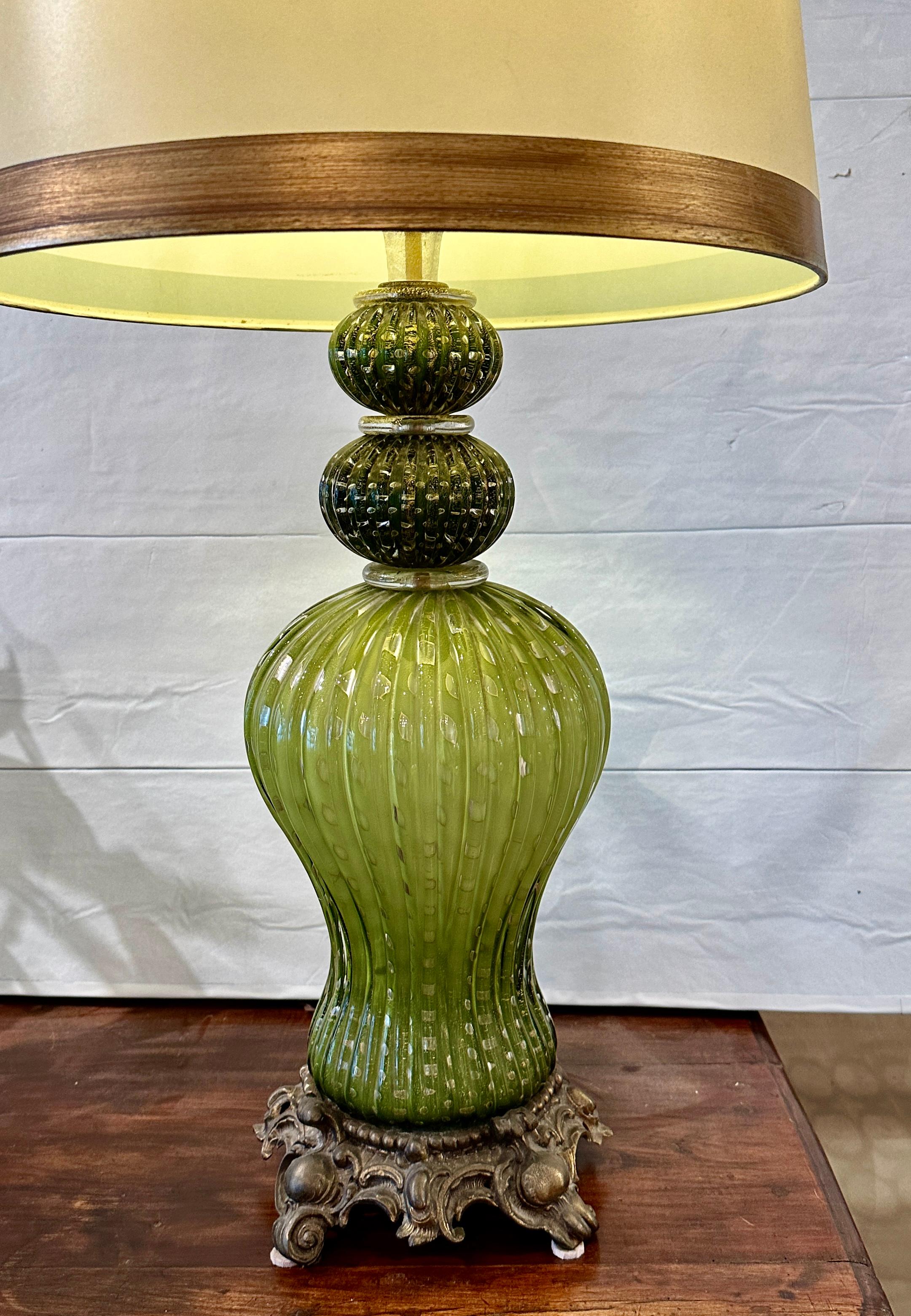Beautiful large Murano glass table lamp.  Hand made in three sections.
Softly fluted shape in gold infused aventurine glass giving a rich shimmering affect along with Bullicante bubble glass technique.  It is topped with darker green fluted balls. 