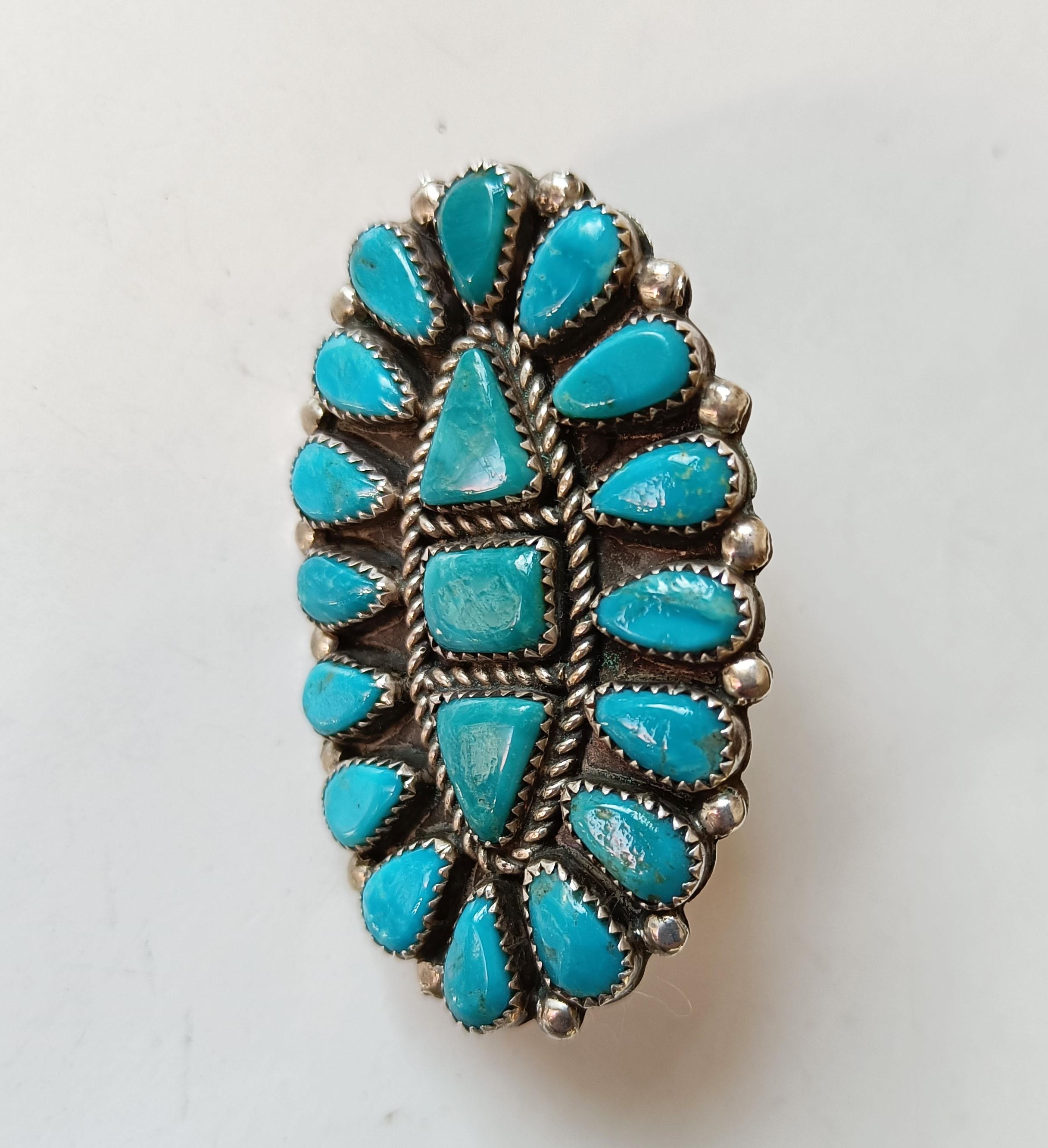 A fine vintage handcrafted Large  Native American Navajo Ring Turquoise silver
A particularly fine and  attractive Navajo ring with multiple small turquoise cabochons  
Makers initials on top underside At?
Measures: 1 1/2 x 2 1/2 inches.    6 x 4 cm