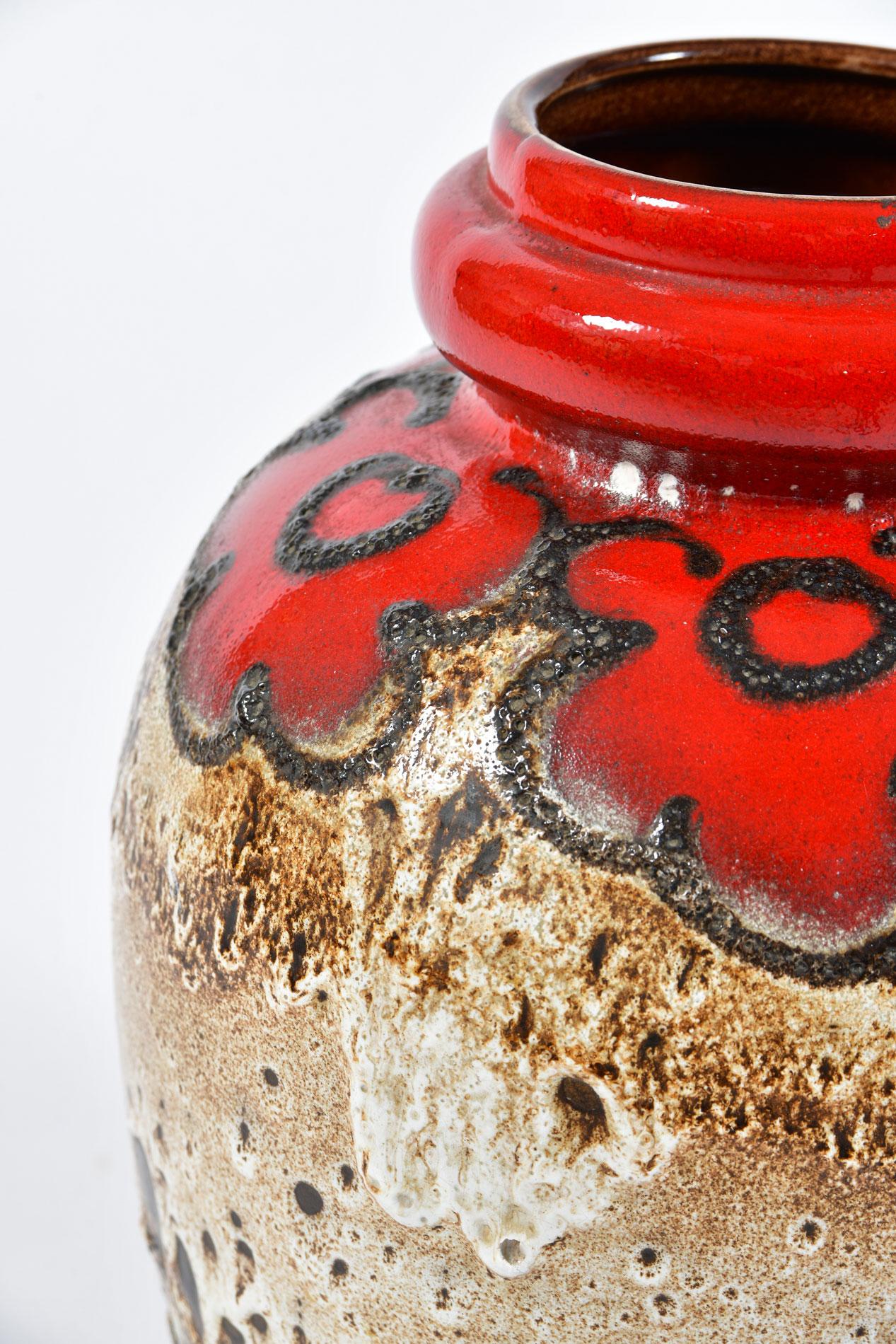 Ceramic fat lava optic pottery in rich red, cream and brown colouring with flower patterning. Marked to the base with ‘Made in West Germany’ and the vase series number 286-42. The 43 cm version is the largest of this series.