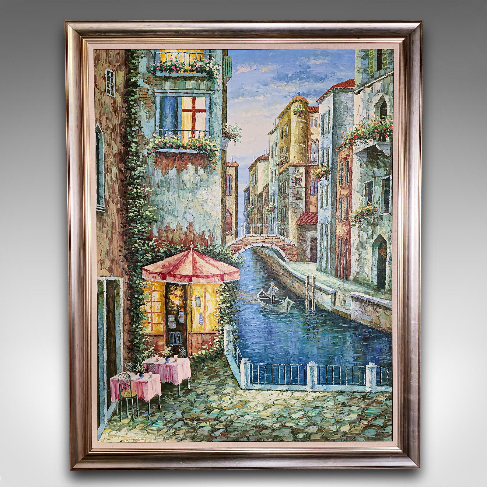 This is a large vintage oil on canvas of Venice. An unsigned Venetian street scene in quality frame, dating to the late 20th century.

A delightful Venetian scene, with a small cafe next to a canal
Presented in a quality later frame with broad,