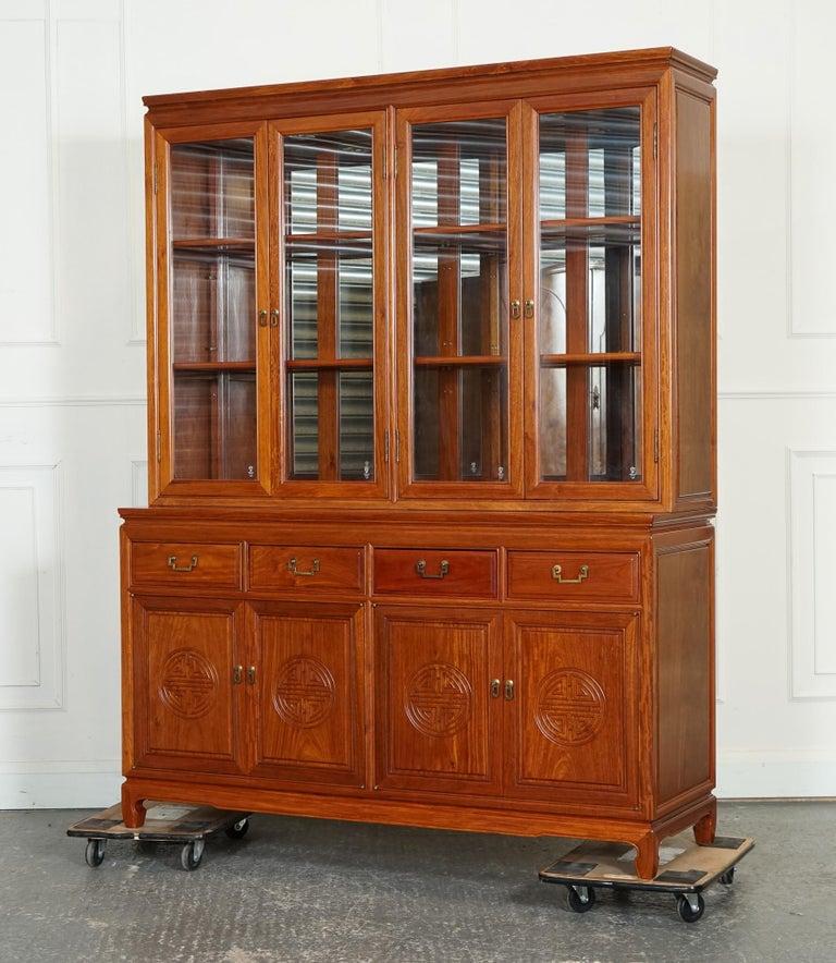 
We are delighted to offer for sale this Large Vintage Oriental Chinese Carved Solid Hardwood Bookcase Display Cabinet.

 A magnificent piece of furniture that exudes timeless elegance and intricate craftsmanship. Crafted from solid hardwood, this