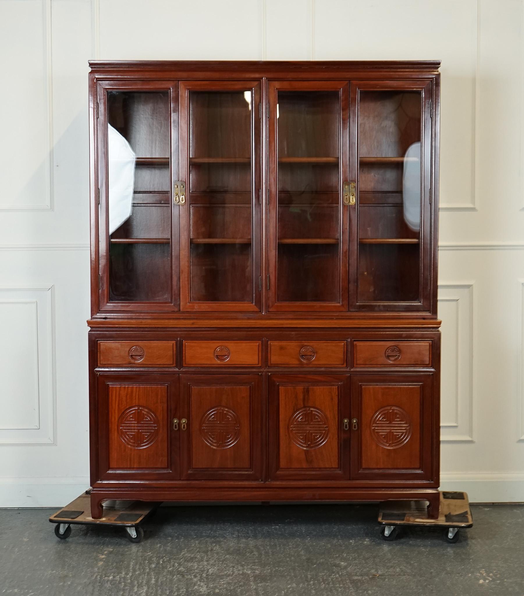 
We are delighted to offer for sale this Oriental Chinese Carved Solid Hardwood Display Cabinet.

This large vintage Oriental Chinese carved solid Hardwood bookcase display cabinet is a magnificent piece that exudes elegance and craftsmanship. Made