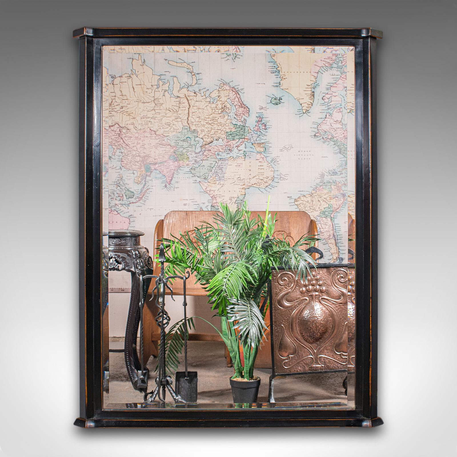 This is a large vintage overmantle mirror. An English, ebonised beech hall or dressing mirror, dating to the late 20th century, circa 1970. A striking piece with Aesthetic Period revival overtones and elegant form.

Substantial overmantle