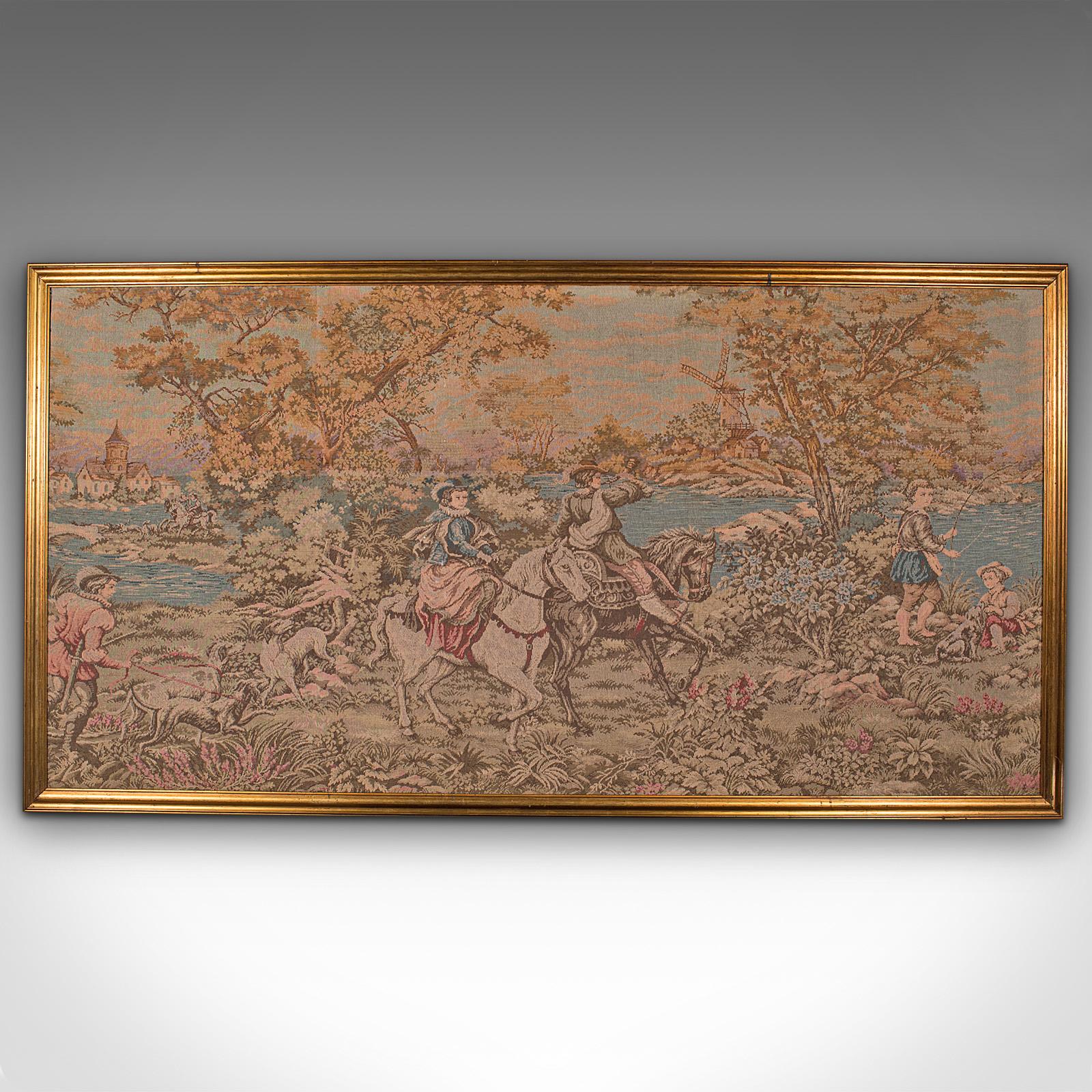 This is a large vintage panoramic tapestry. A Continental, needlepoint decorative panel with gilt frame, dating to the early 20th century, circa 1930.

Of wide proportion with charming scenery and interest
Displays a desirable aged patina