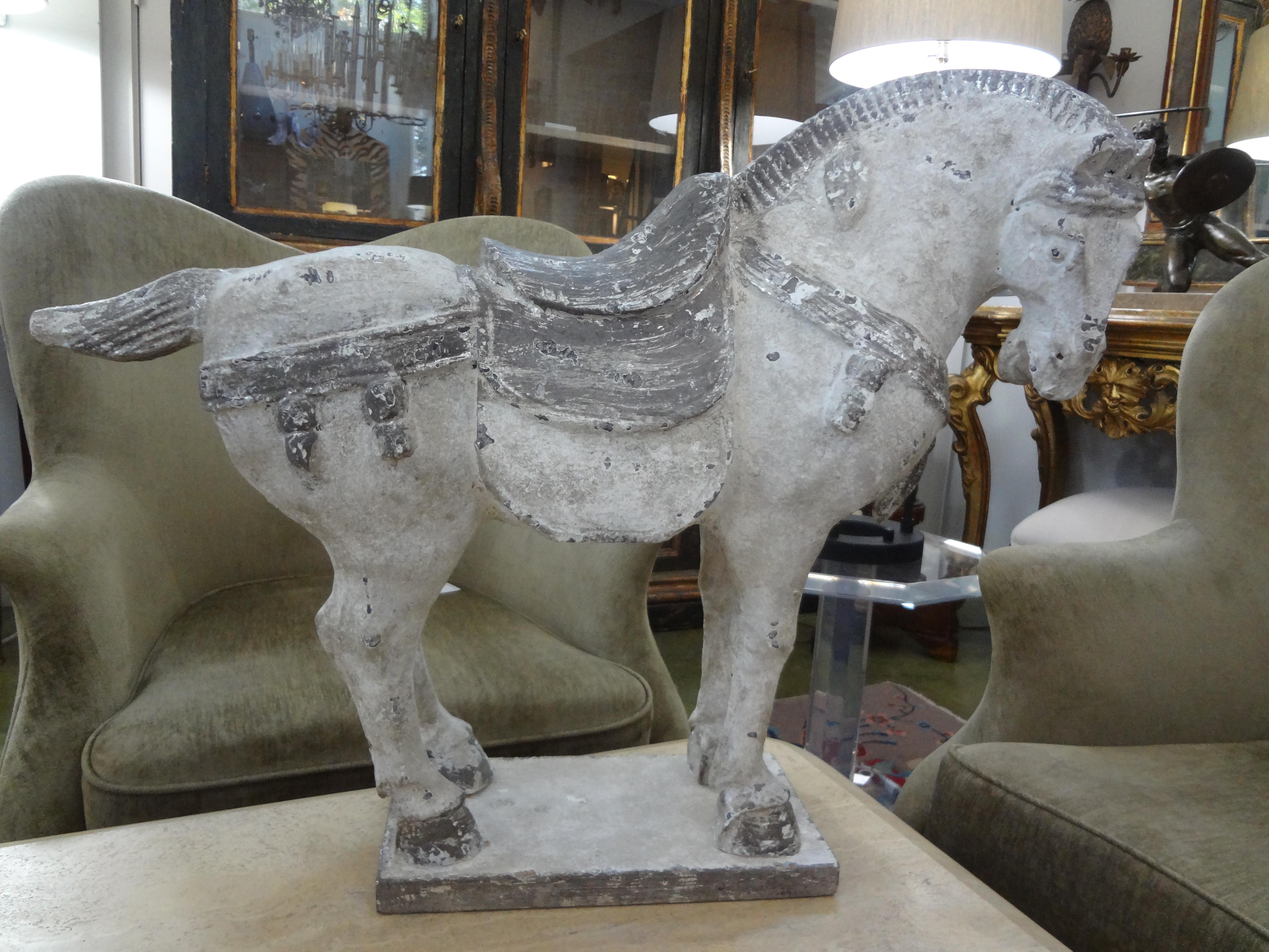 Large stylized plaster Tang style horse.
Large vintage stylized polychrome plaster tang style horse figure. This well detailed Hollywood Regency tang dynasty style horse figure with a saddle and turned head modeled in a standing pose with an arched